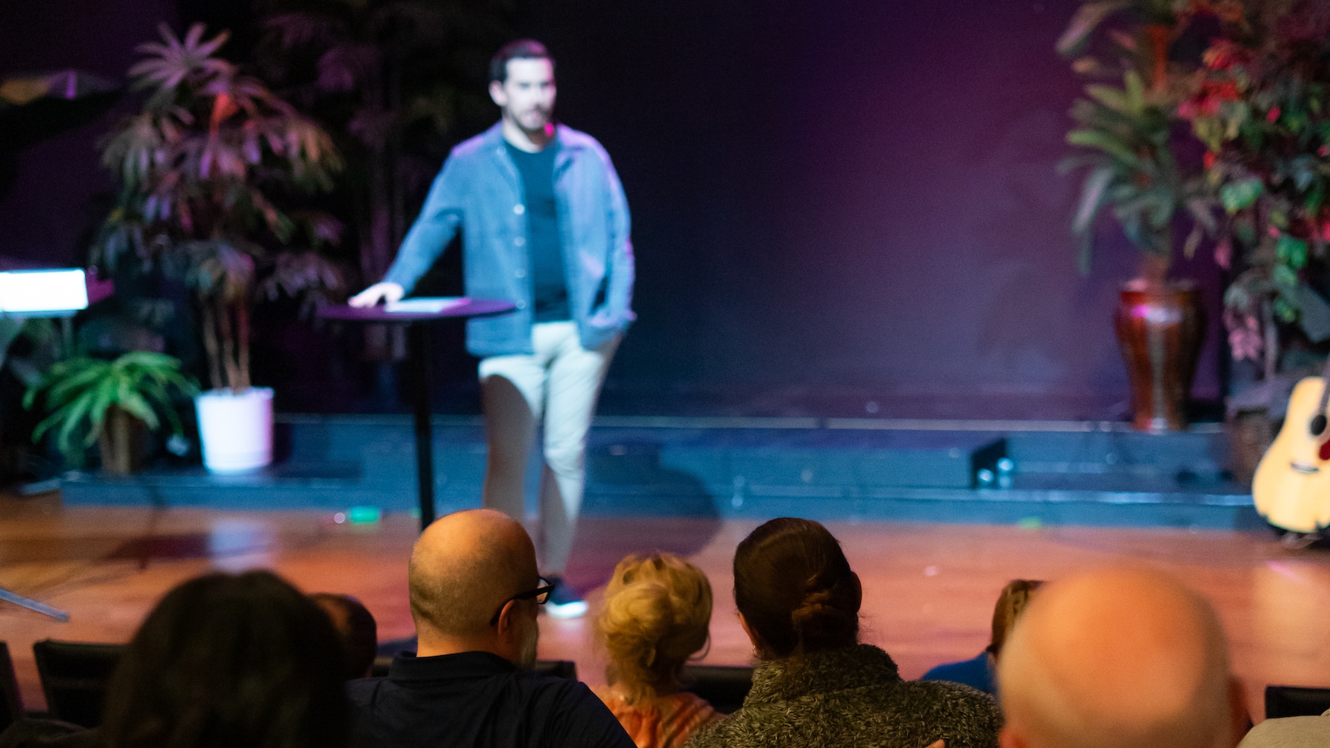 A photo of Rob Russell speaking from stage to the congregation at Restoration Community Church in Mandeville, Louisiana