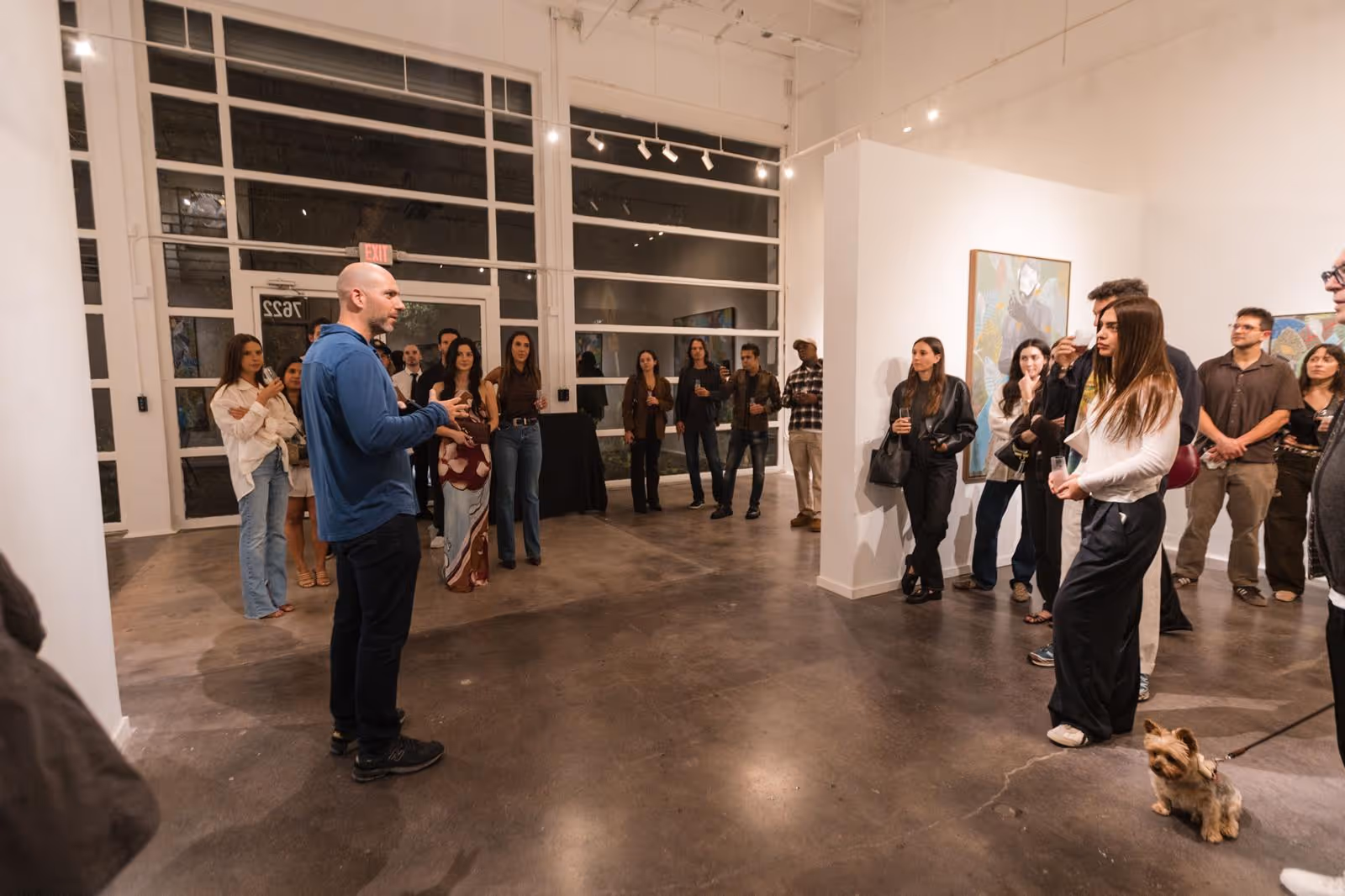 Billy Tartour ,founder of the Opa Projects art gallery in Miam,i is speaking to a group of collectors