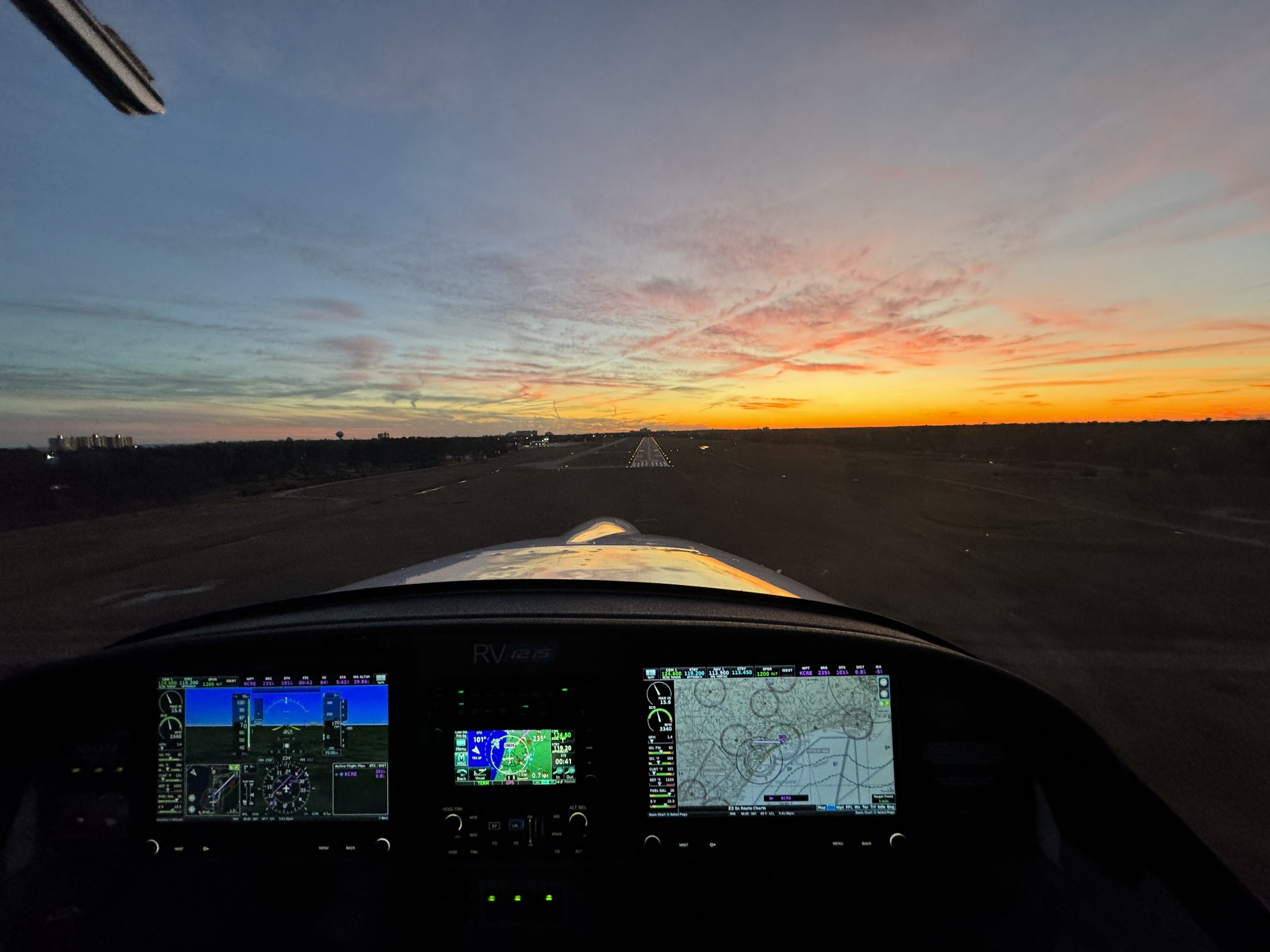 Digital flight displays in a Falcon RV-12iS cockpit overlooking the runway at sunset