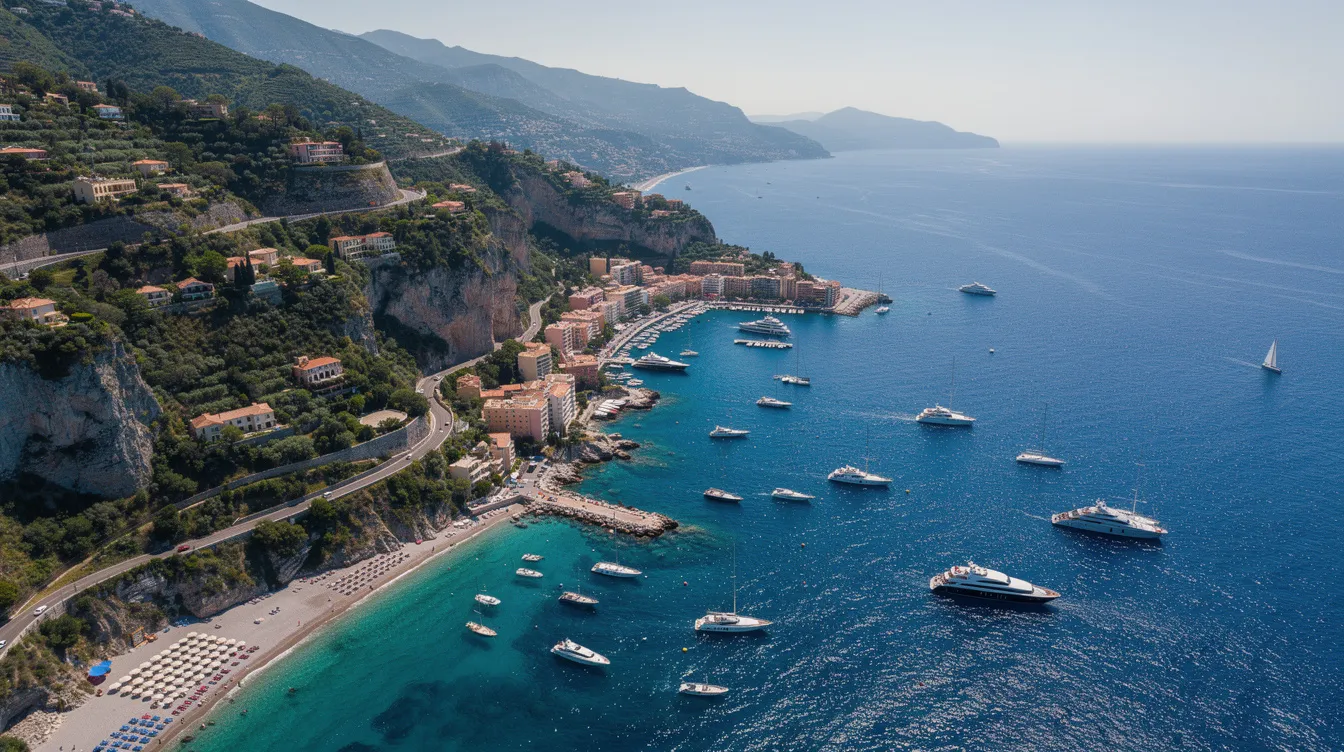 An aerial view captures the stunning coastline near Nice and Monaco, showcasing the vibrant blue Mediterranean waters dotted with luxurious yachts. This picturesque scene highlights the allure of private jet travel to the French Riviera, a popular destination for those seeking exclusive experiences and adventure.