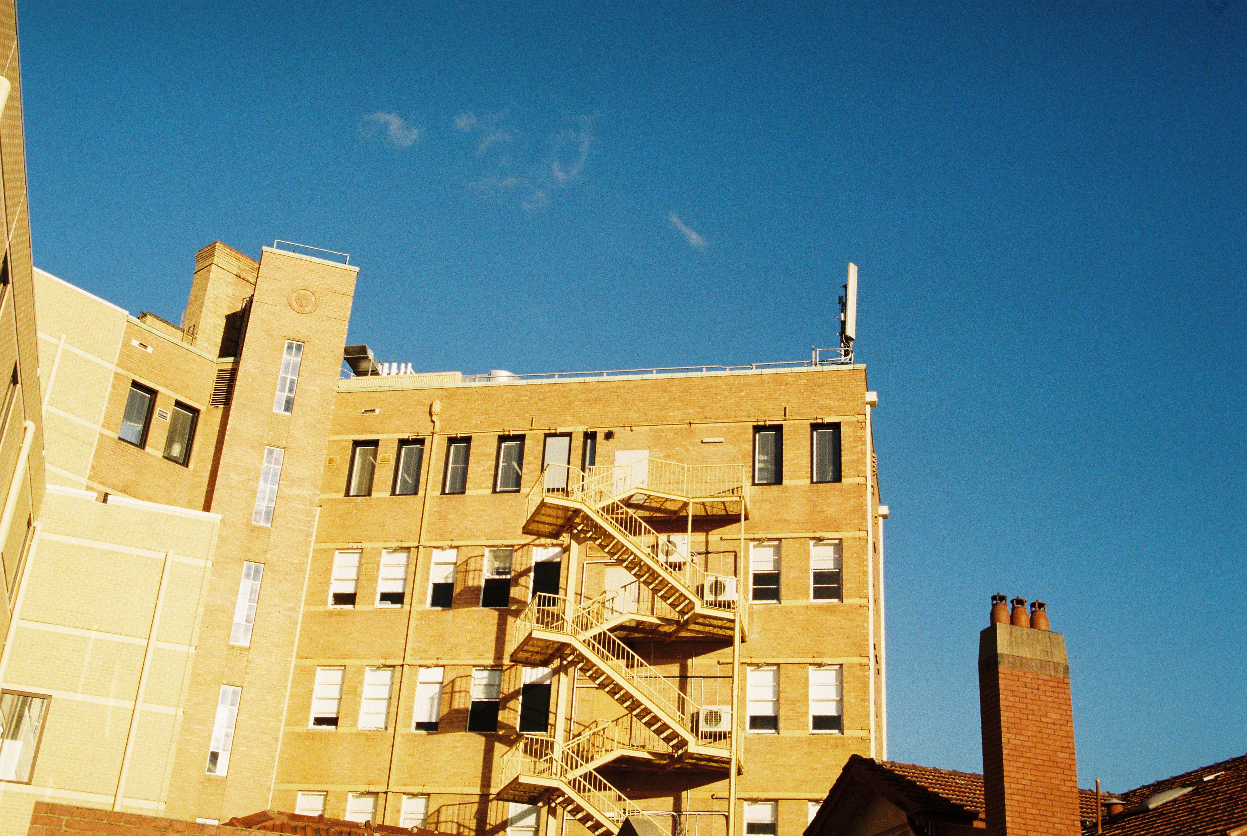 An image of cream buildings against a clear blue sky.