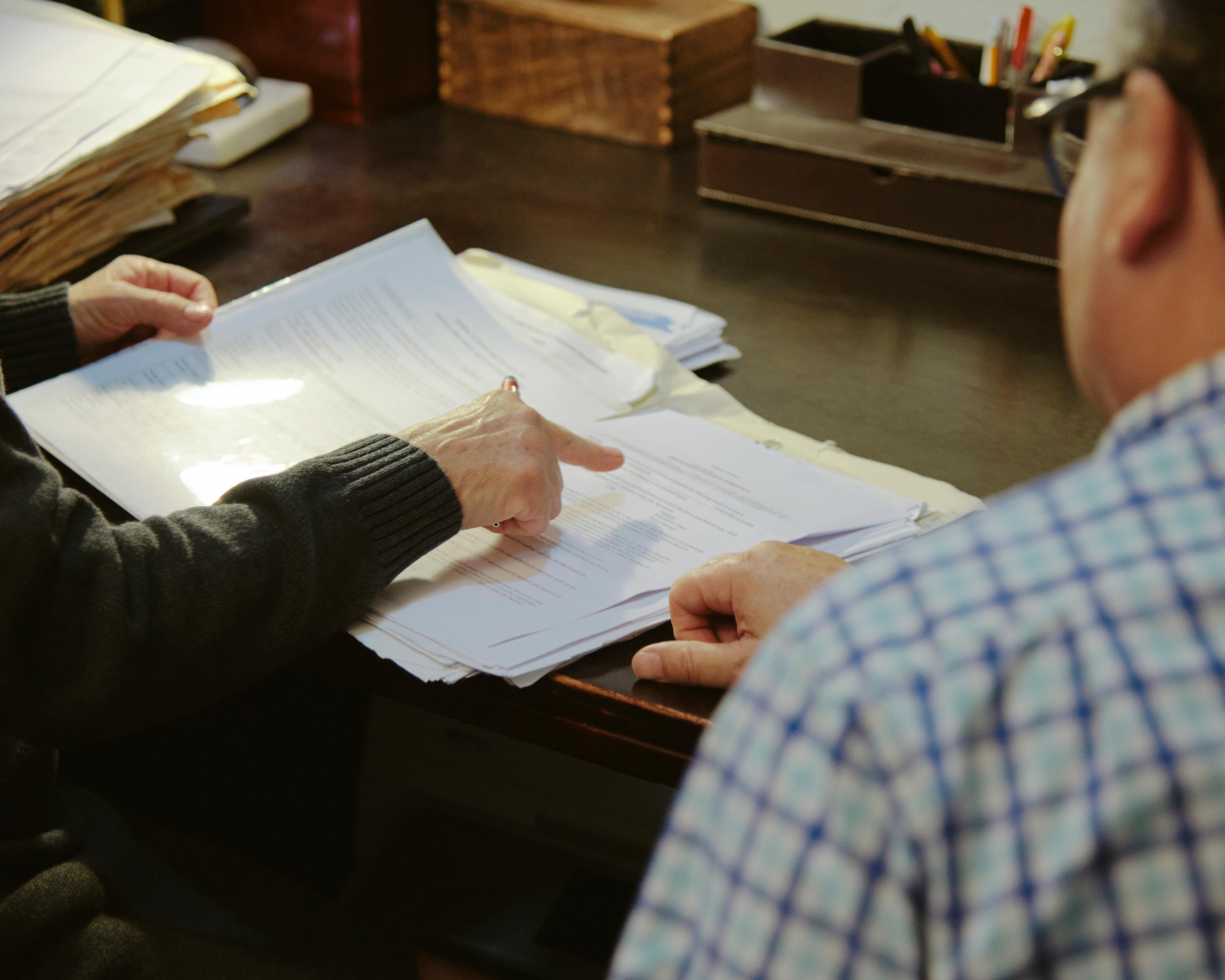 An image of a lawyer taking a client through an important looking document.