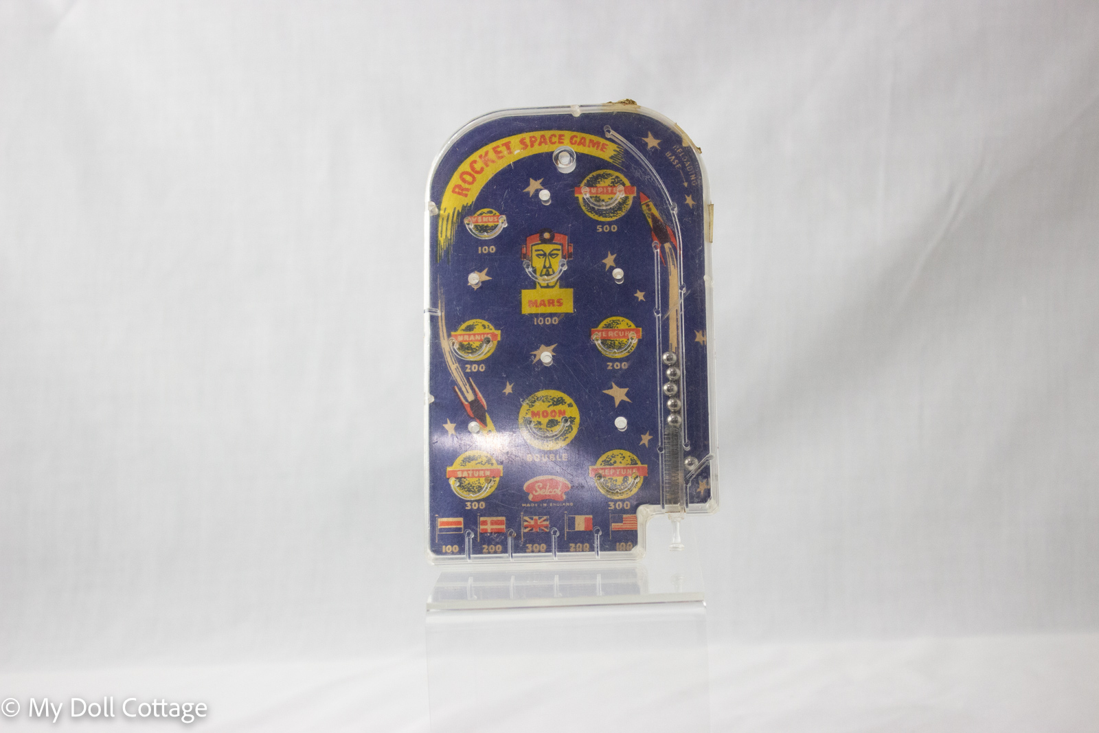 Vintage Selcol Rocket Space Game handheld pinball toy, blue background with rockets, planets, and national flags. Collectible mid-century toy from My Doll Cottage heritage collection in Bunbury, Australia.