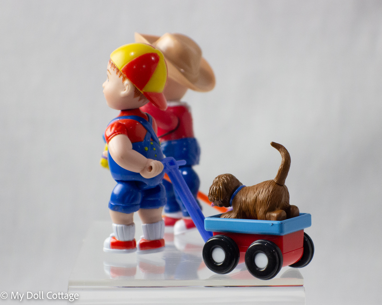 Angled display view of both Baby Lil’s wind-up toys together, showing their colourful painted details and charming 1990s design