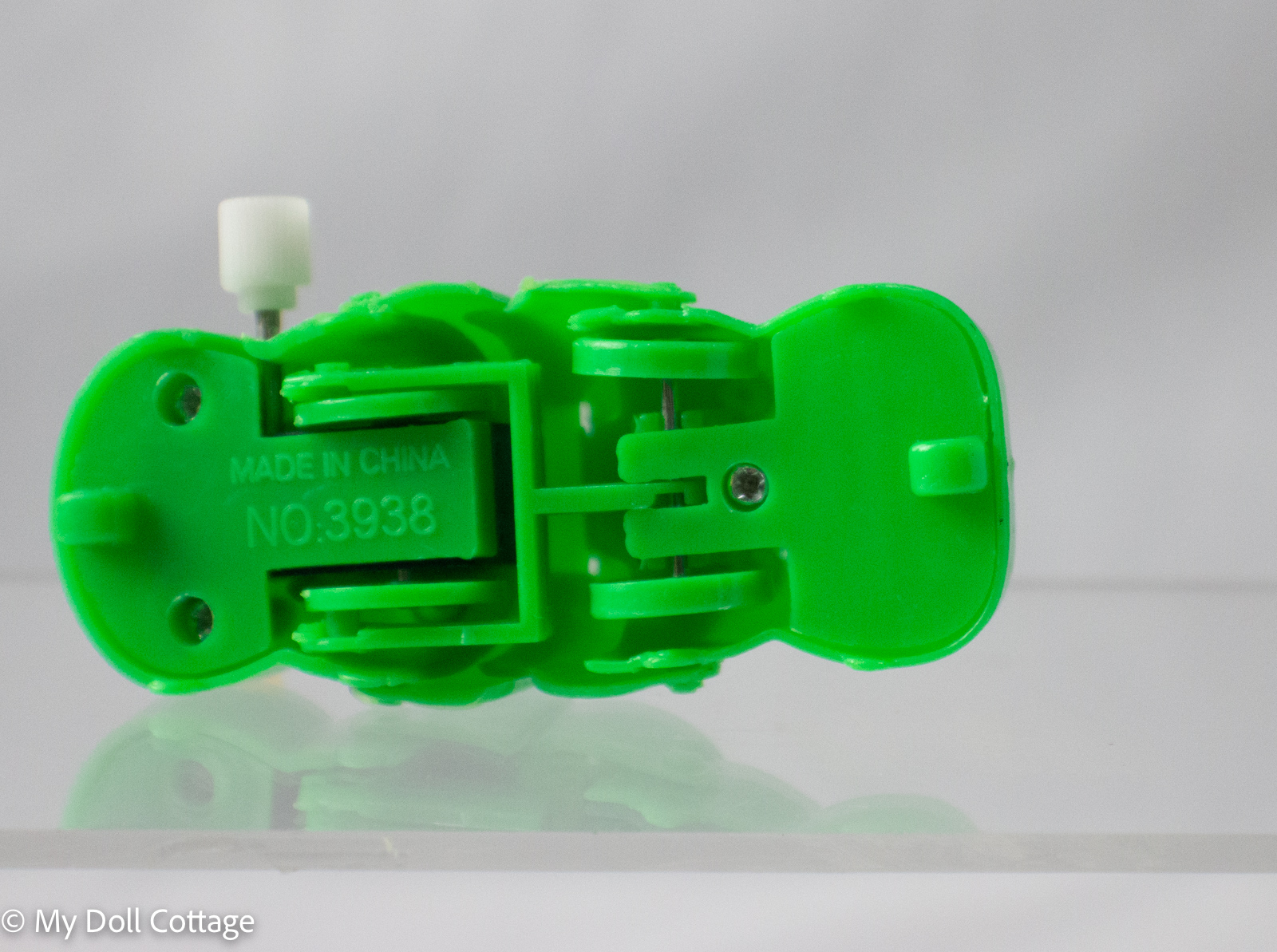 Rear/underside view showing “Made in China No. 3938” imprint and wind-up mechanism details.