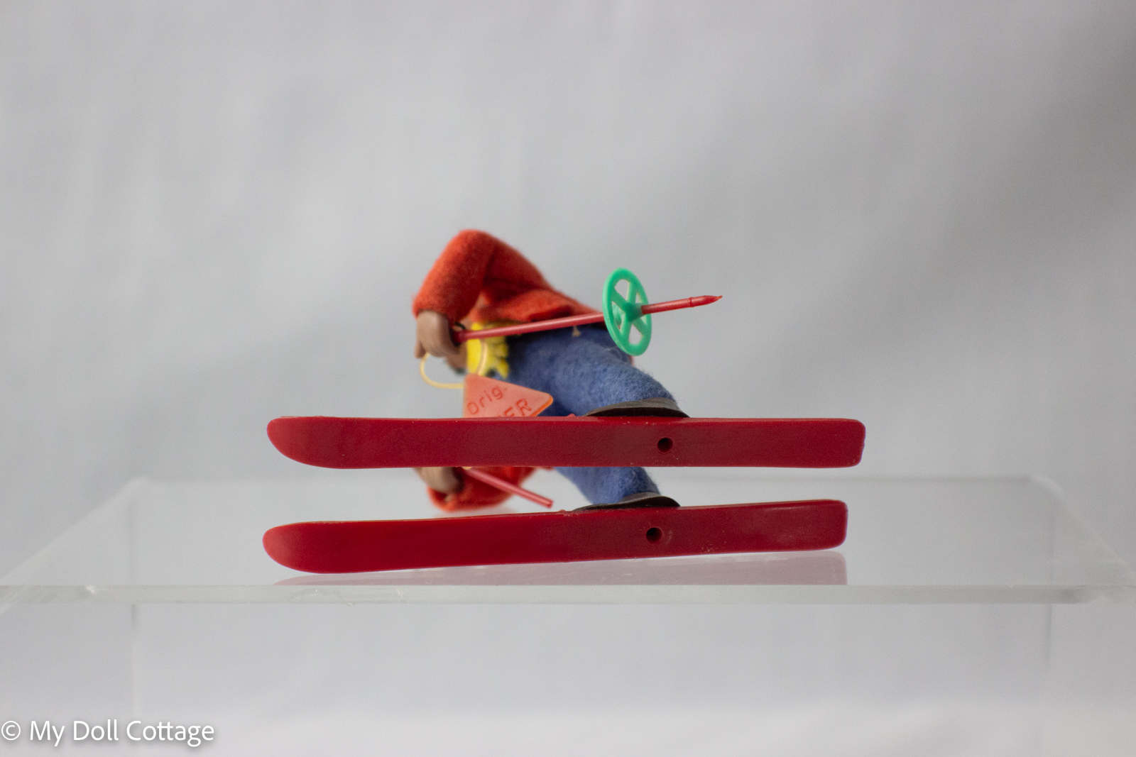 Bottom view of Peter the Snow Skiing Hedgehog figurine showing skis and construction details.