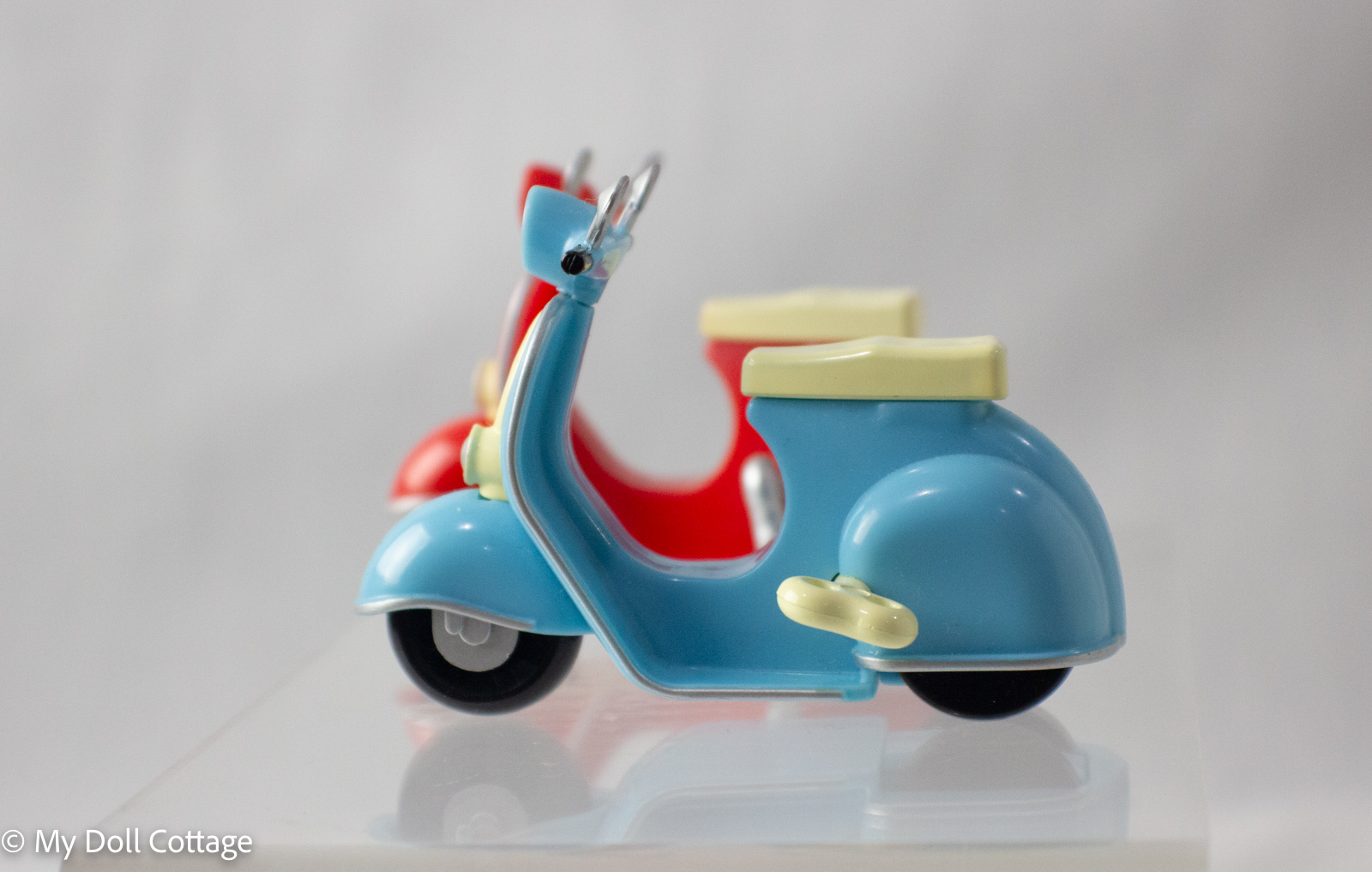 Side profile of blue 1980s wind-up moped with cream detailing.