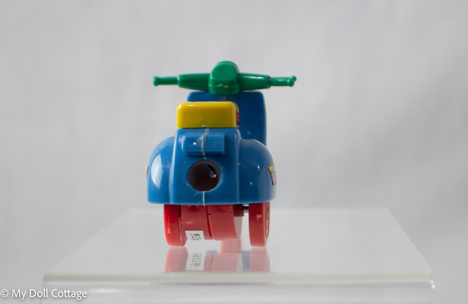 Rear view of scooter pencil sharpener with sharpener hole visible.