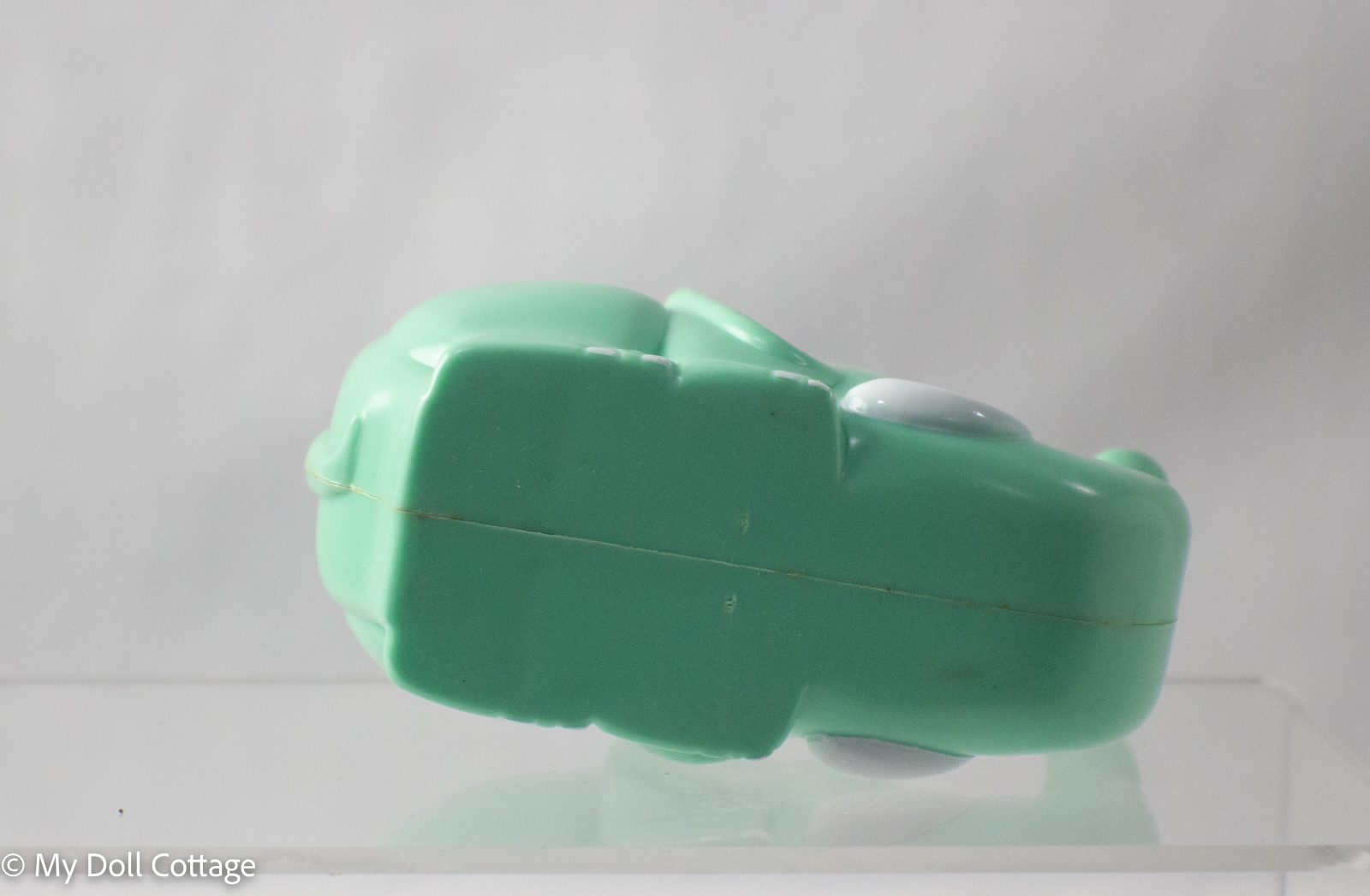 Base view of green elephant sticky tape dispenser.