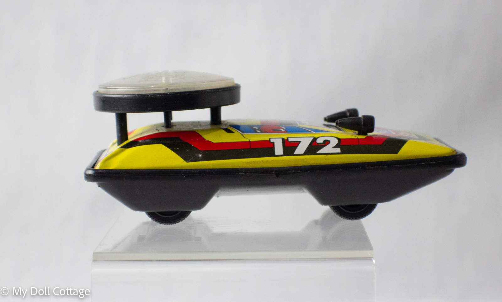 Opposite side profile of tin hovercraft with roulette spinner top.