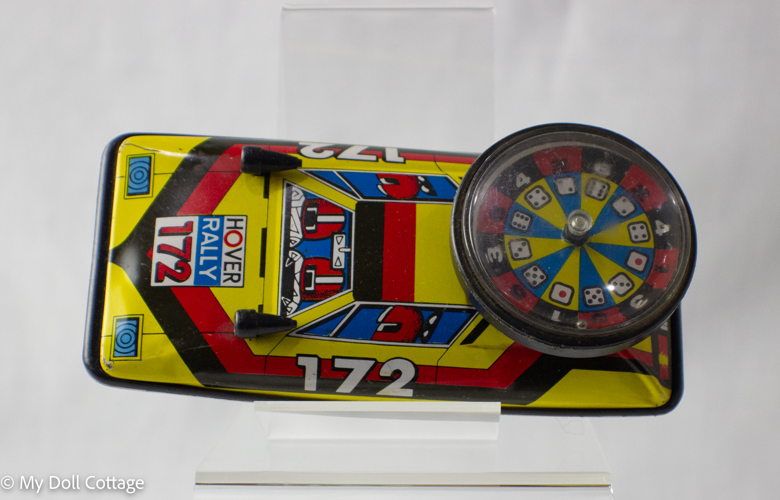 Overhead view showing colourful roulette spinner and “Hover Rally 172” litho detail.