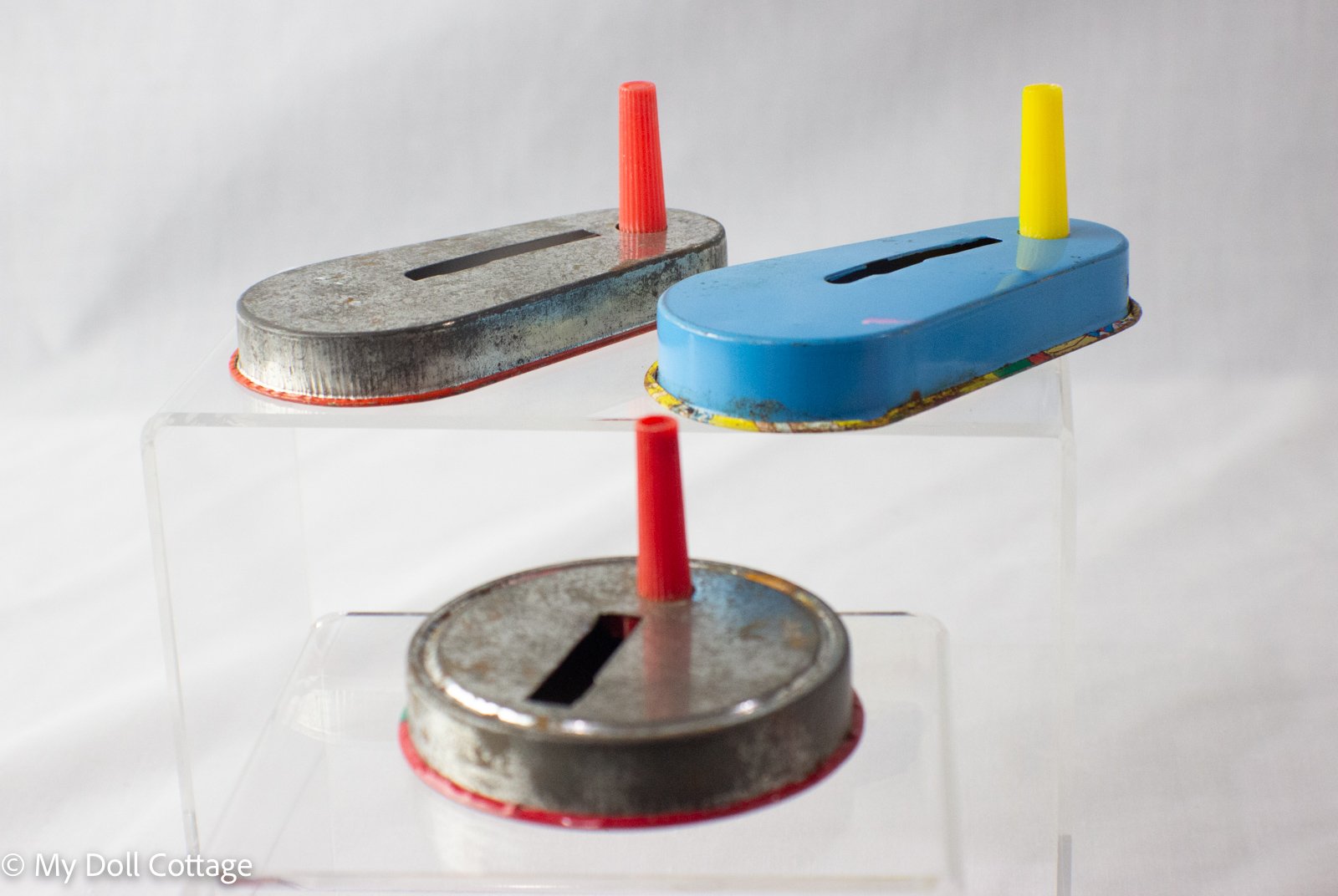 Set of three 1950s Japanese lithographed tin spinning noisemakers with clown, jester, and circus designs, made in Japan, My Doll Cottage collection.”