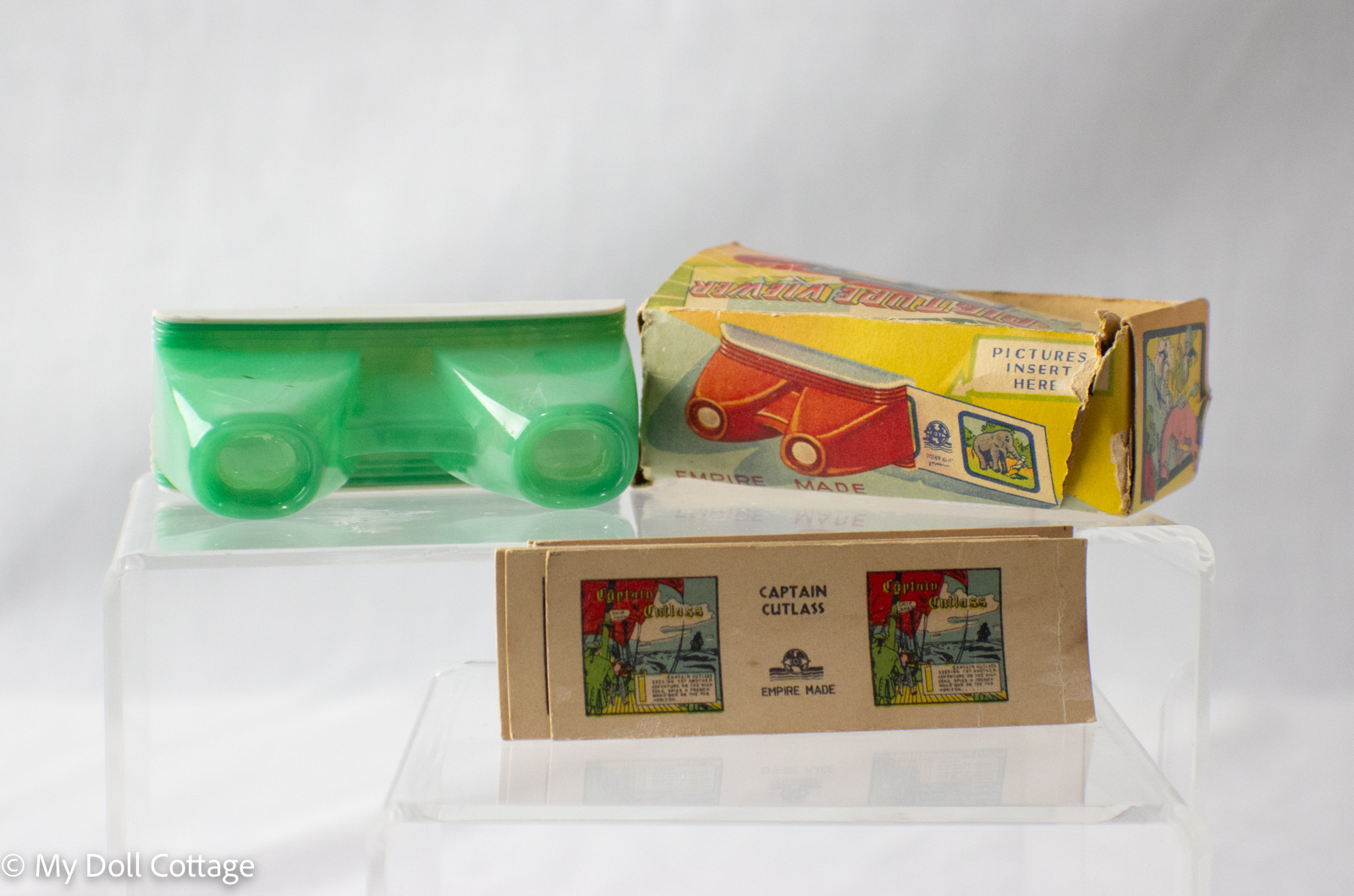 1950s Empire Made green plastic 3D picture viewer with box and Captain Cutlass cards displayed, My Doll Cottage collection.