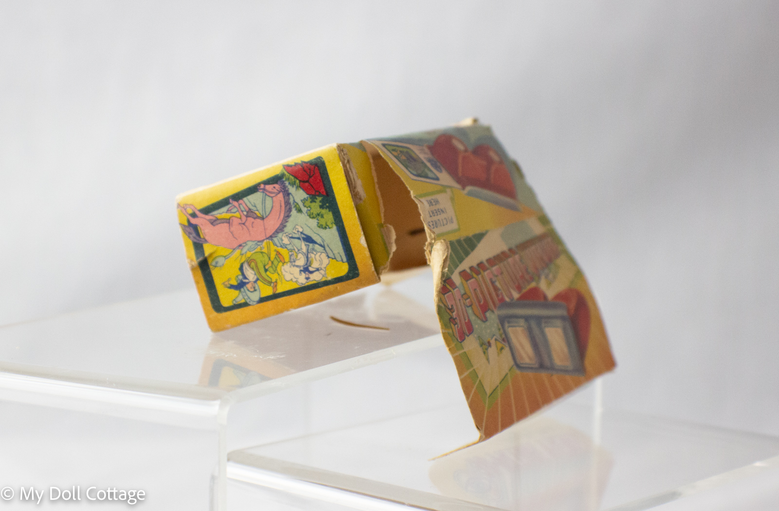 Side view of Empire Made 3D Picture Viewer box with illustrations of children and animals, showing wear and tear.
