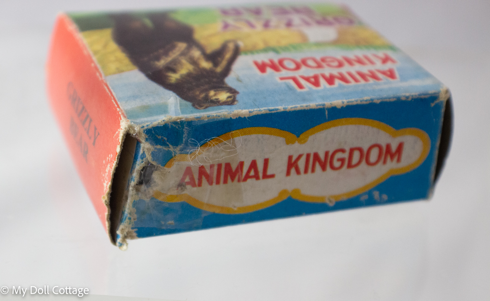 Close-up of Animal Kingdom box top with red and blue graphics and visible age wear.