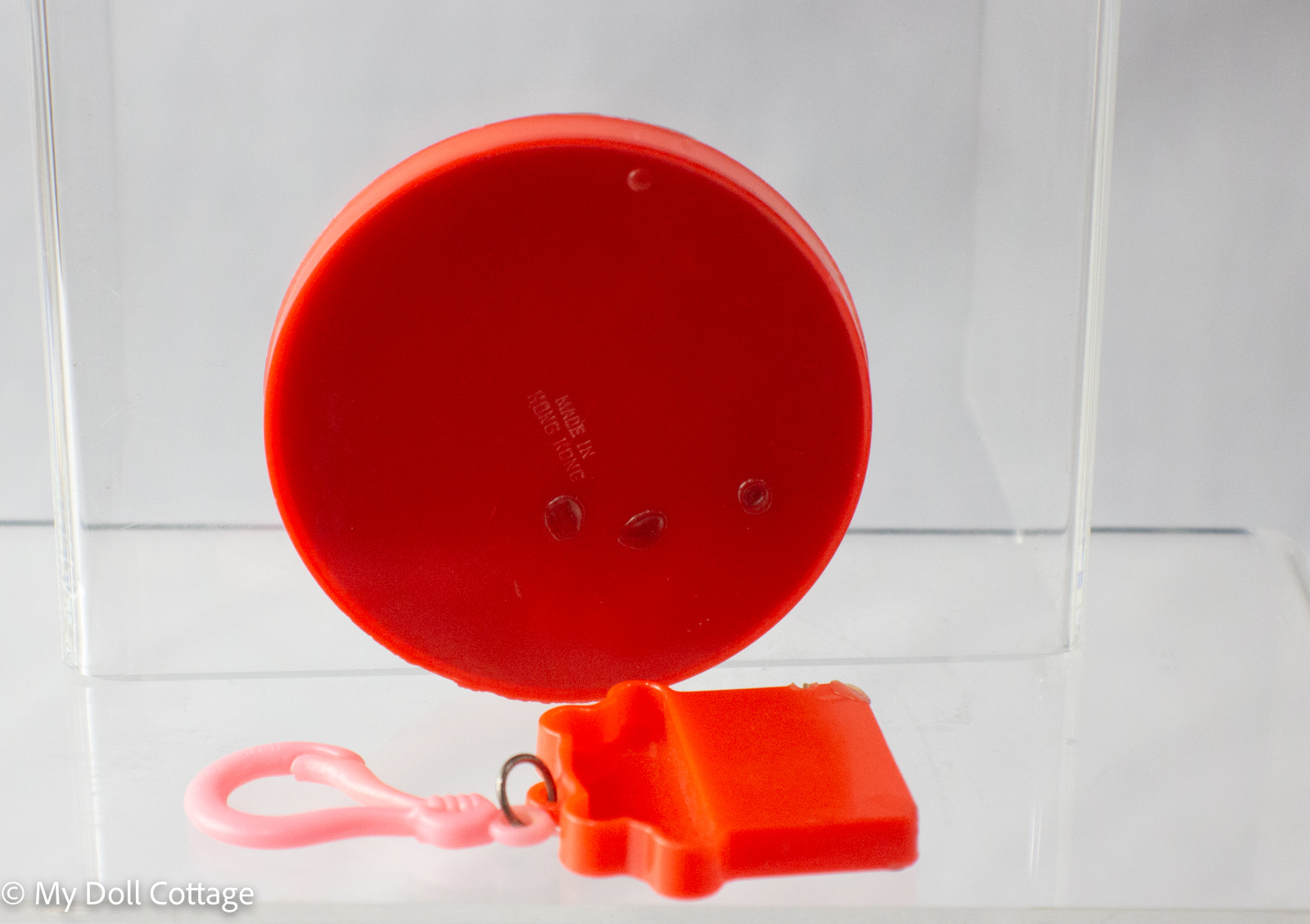 Rear view showing plain red backs with “Made in Hong Kong” marking.