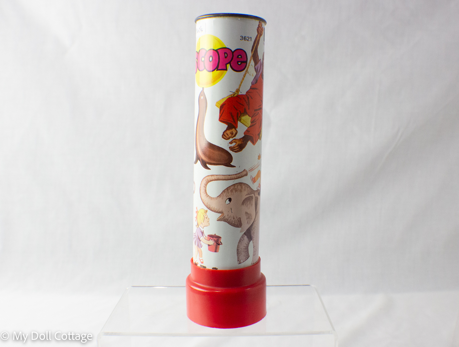 Upright view of 1960s Zooscope kaleidoscope with red base and animal graphics