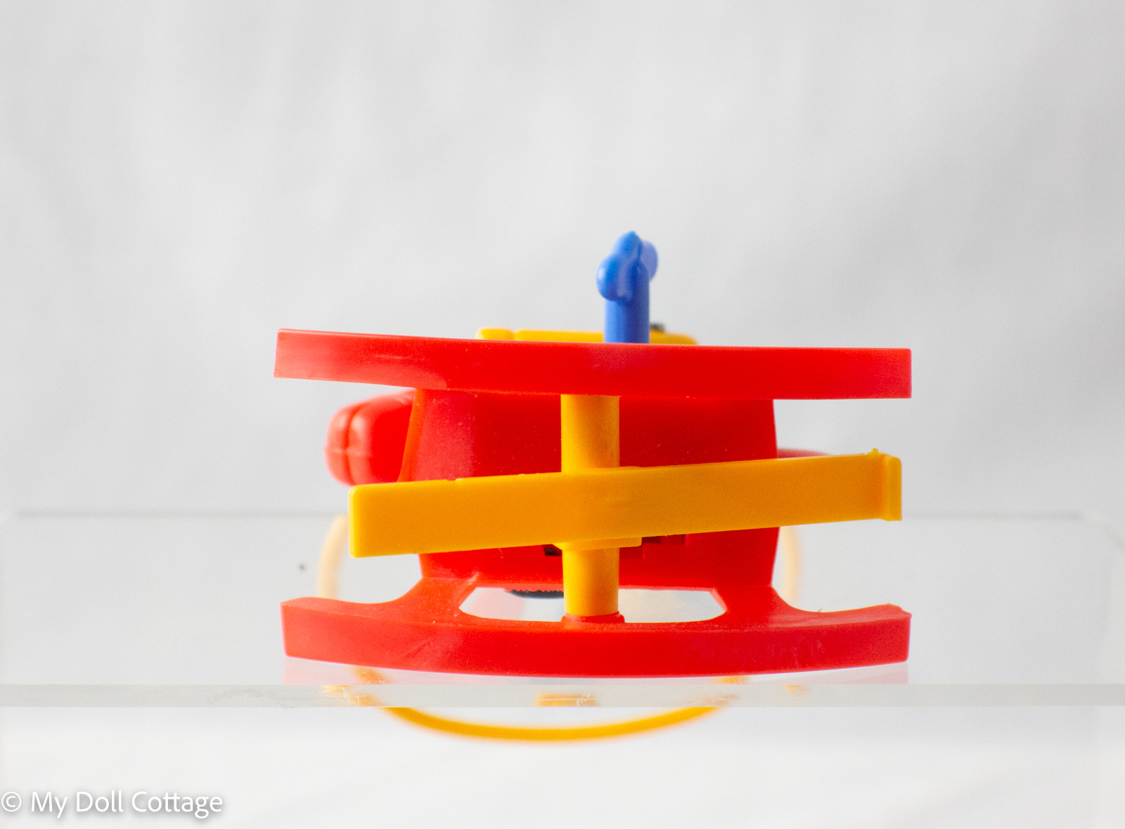 Underside showing yellow base supports and rocking mechanism.