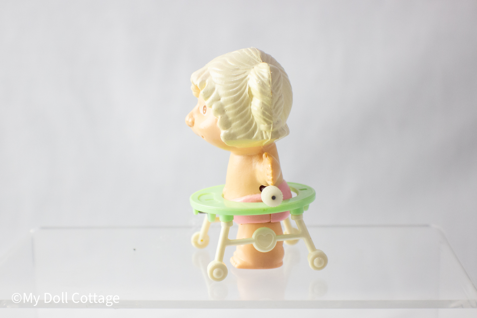 Side view showing the molded pigtail detail and baby walker mechanism.