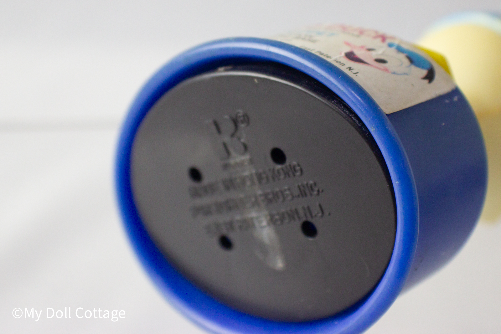 Underside view of blue base showing embossed Kohner Bros. and Hong Kong manufacturing mark