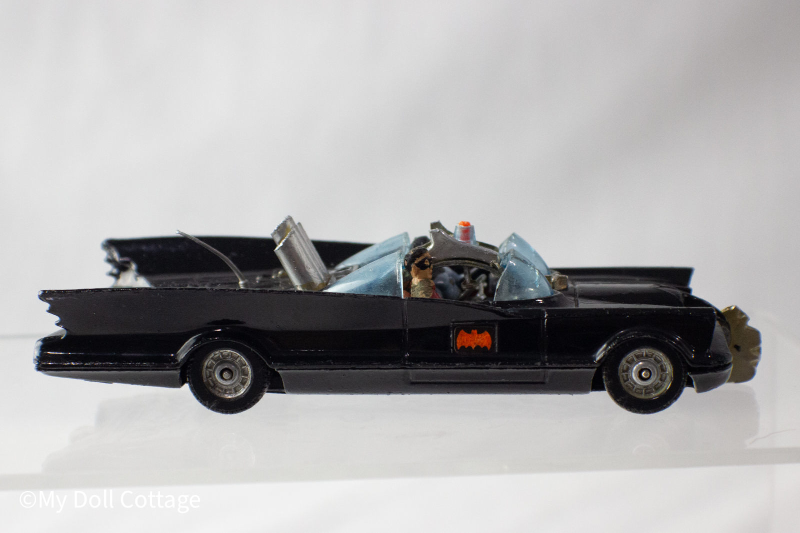 Side profile showing Batman and Robin seated figures with black diecast body and red Bat logo