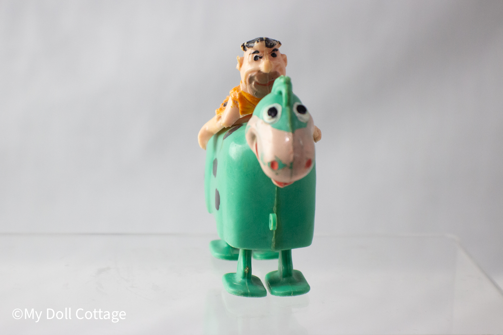 - Front view showing Fred’s face and dinosaur’s wide snout with cartoon eyes.