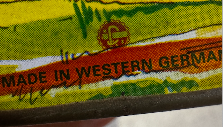 Underside view showing plain gold tin base showing the logo.