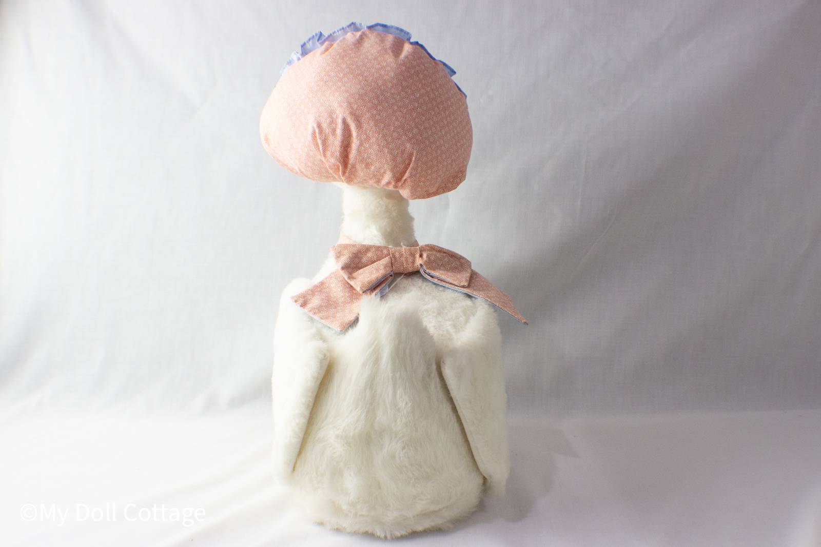 - Rear view showing bonnet bow and plush feathered texture of Talking Mother Goose.