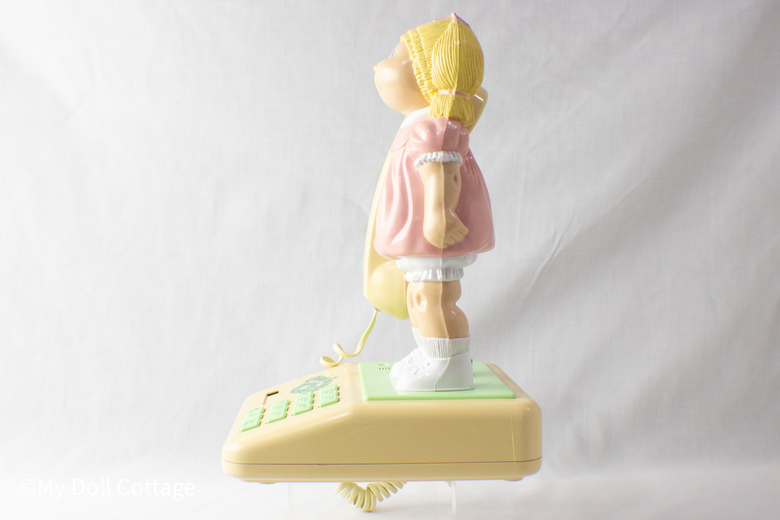 Side profile of 1984 Cabbage Patch Kids telephone with doll figure holding handset.
