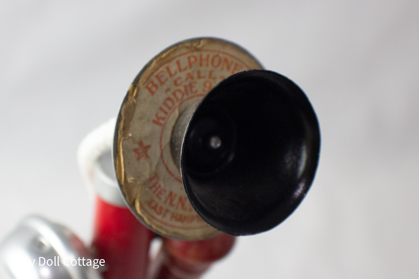 - Close-up of black mouthpiece showing worn Bell Phone 'Call Kiddie 9432' label.