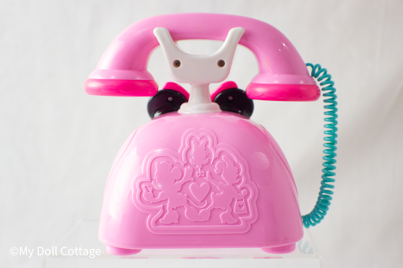 Back side of the toy phone displaying an embossed heart design on the casing.