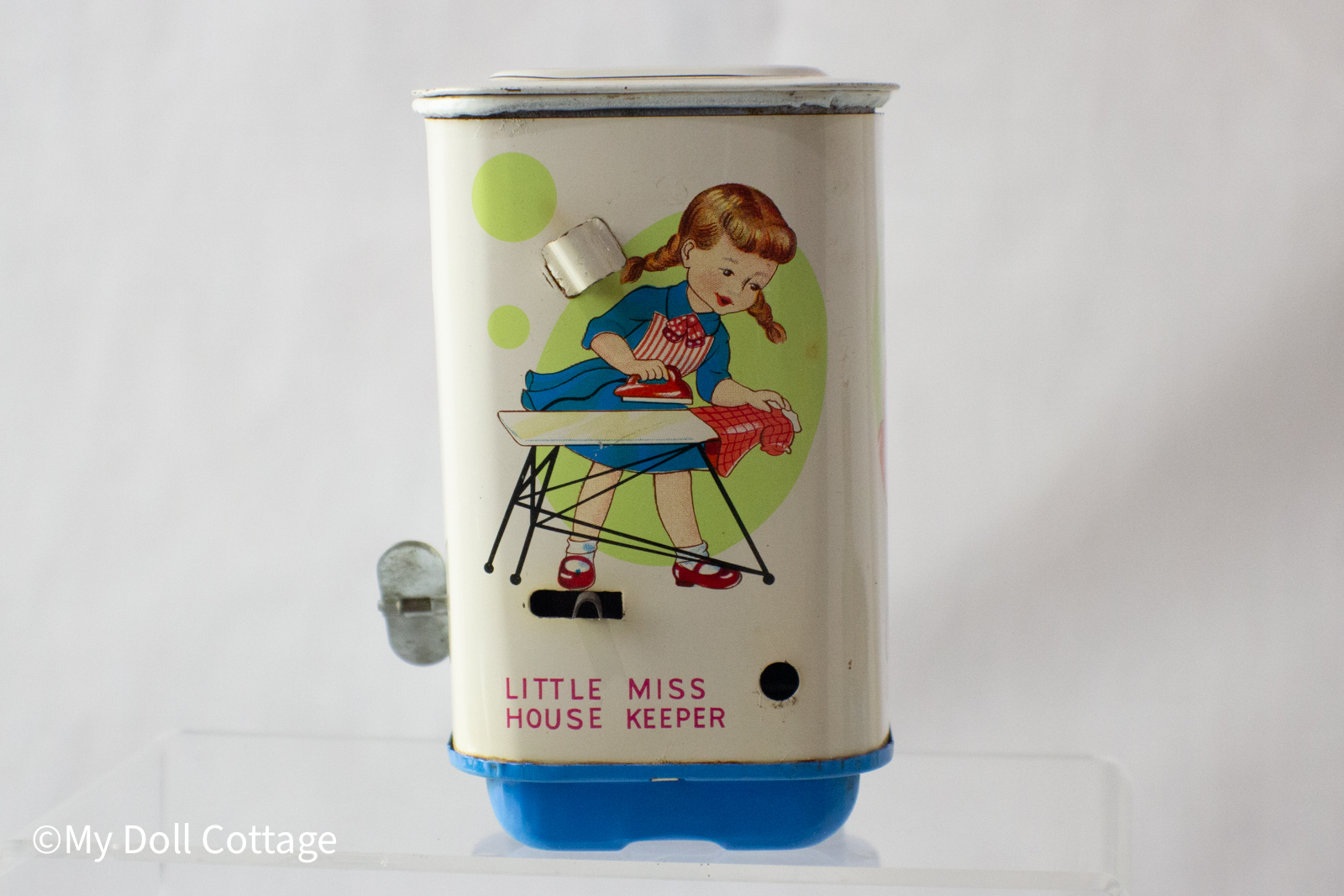 7.	Side panel illustration of two girls facing each other over the caption “Automatic Washing Machine”.