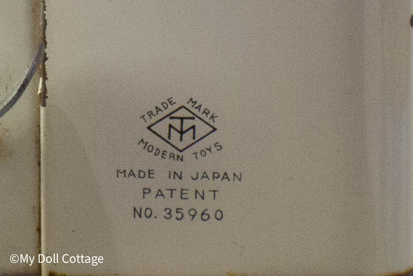 4.	Close-up of the Modern Toys trademark stamp on the back of the washing machine.