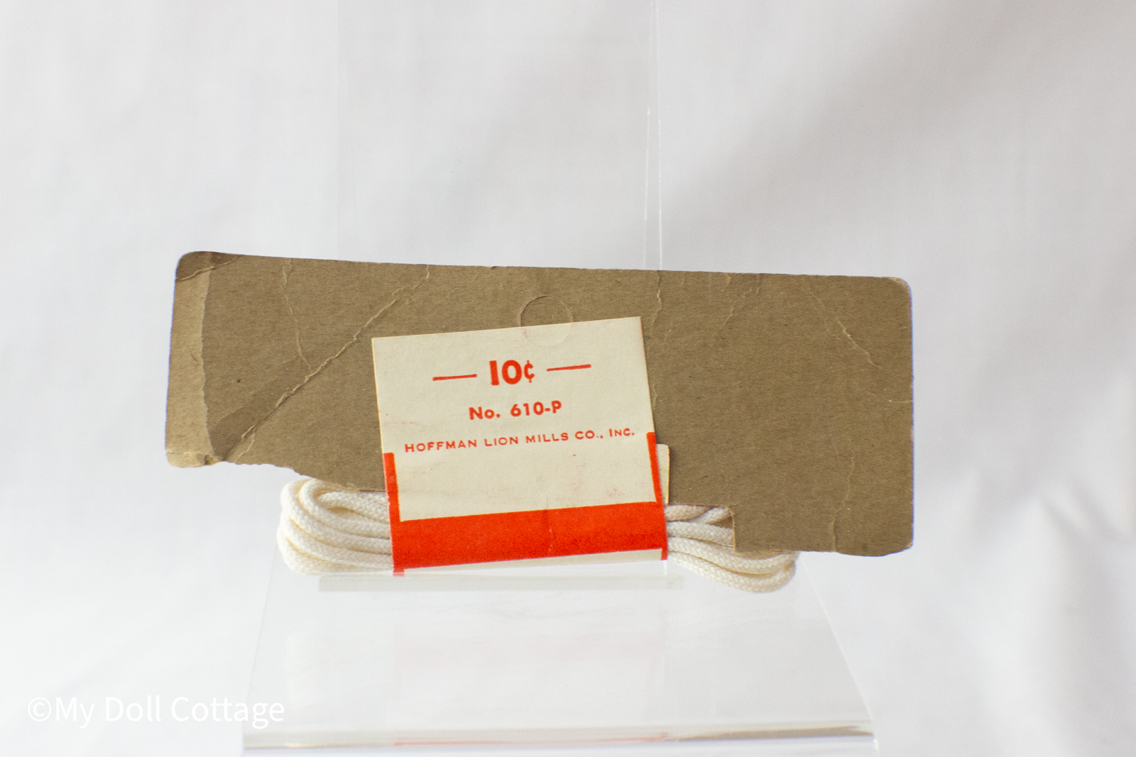 •	Close-up showing the Hoffman Lion Mills Co. price card printed “10¢ No. 610-P”.