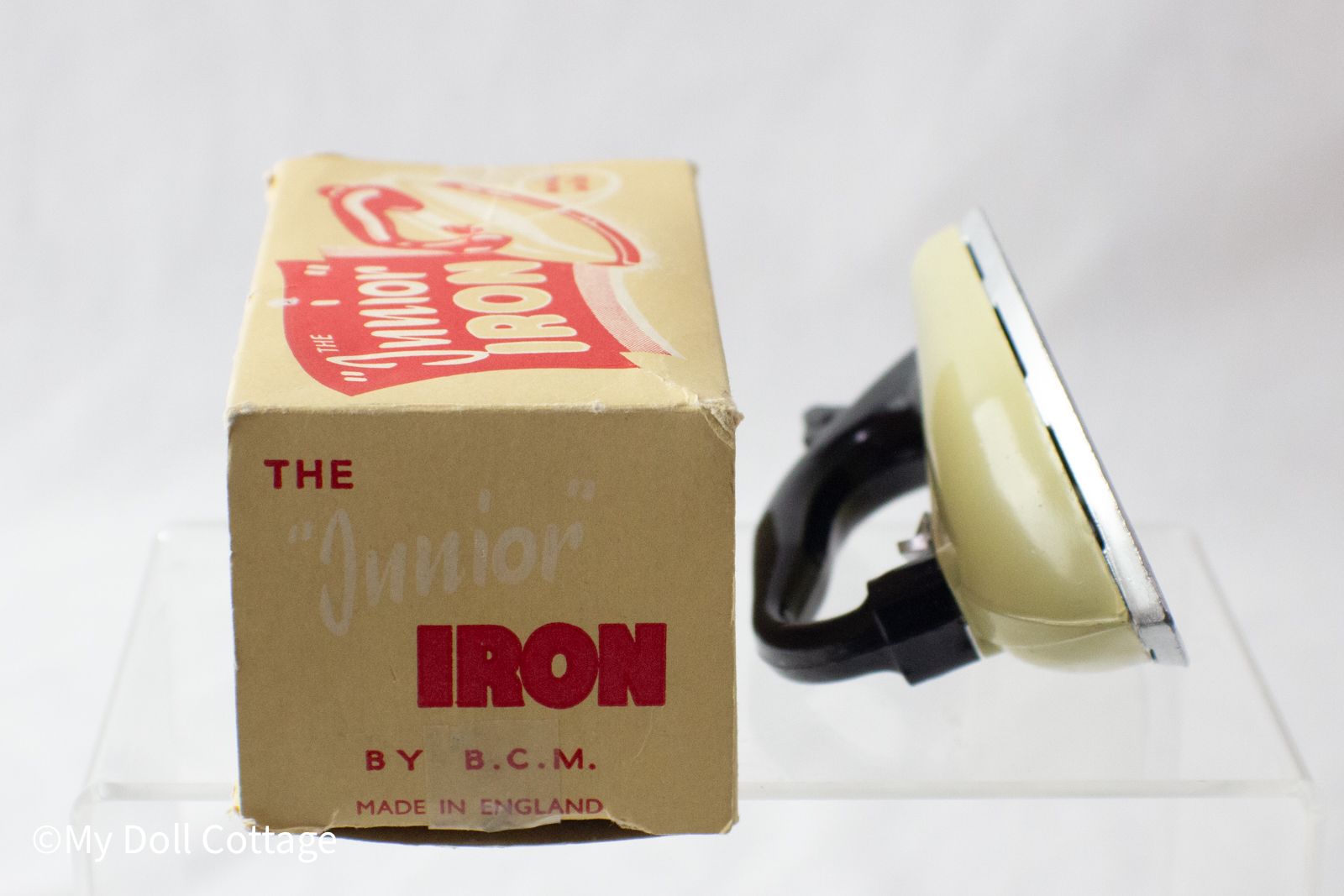 Three‑quarter view of the BCM Junior Iron showing the black handle and yellow metal body.