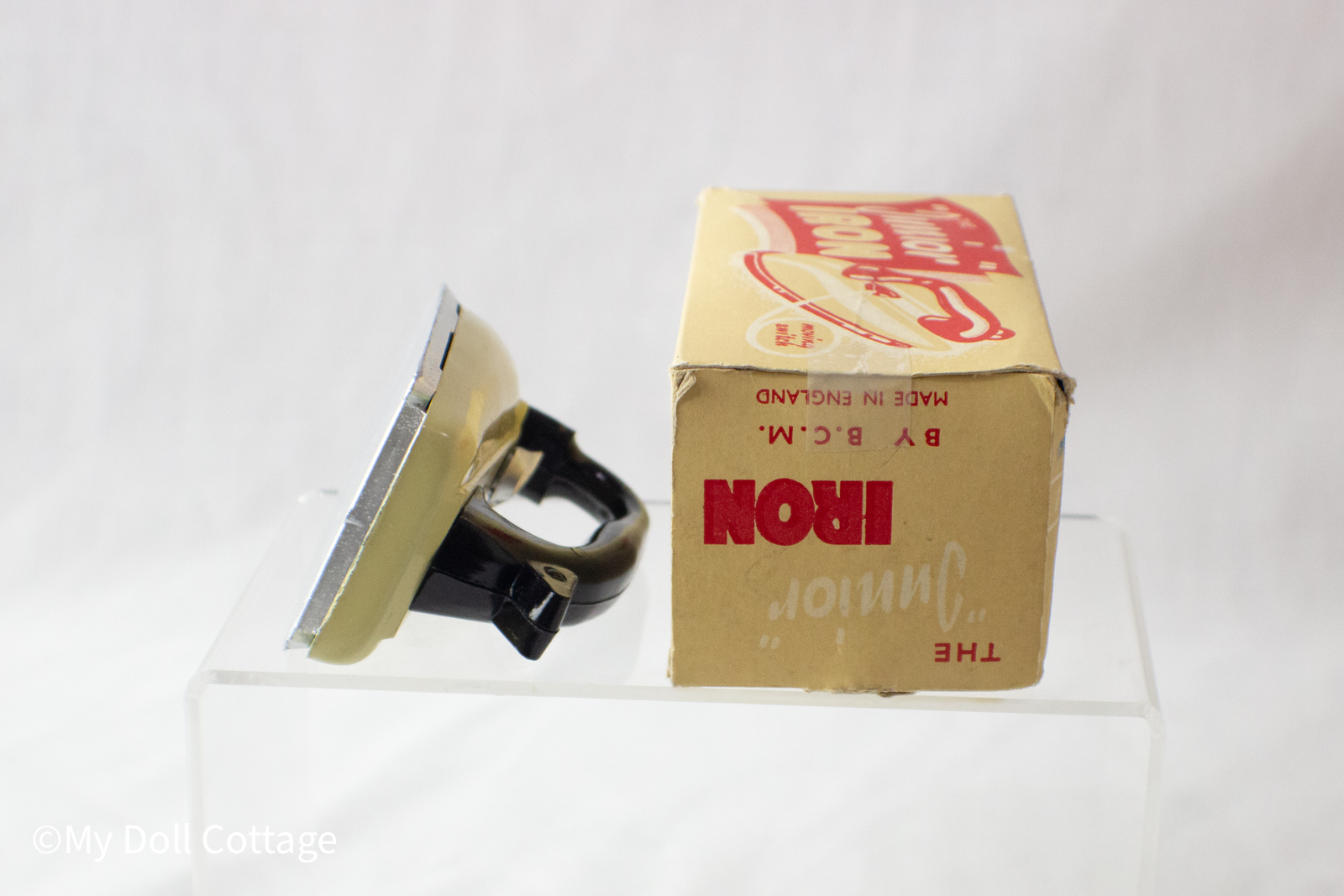 Side angle of the BCM Junior Iron positioned next to its original cardboard box.