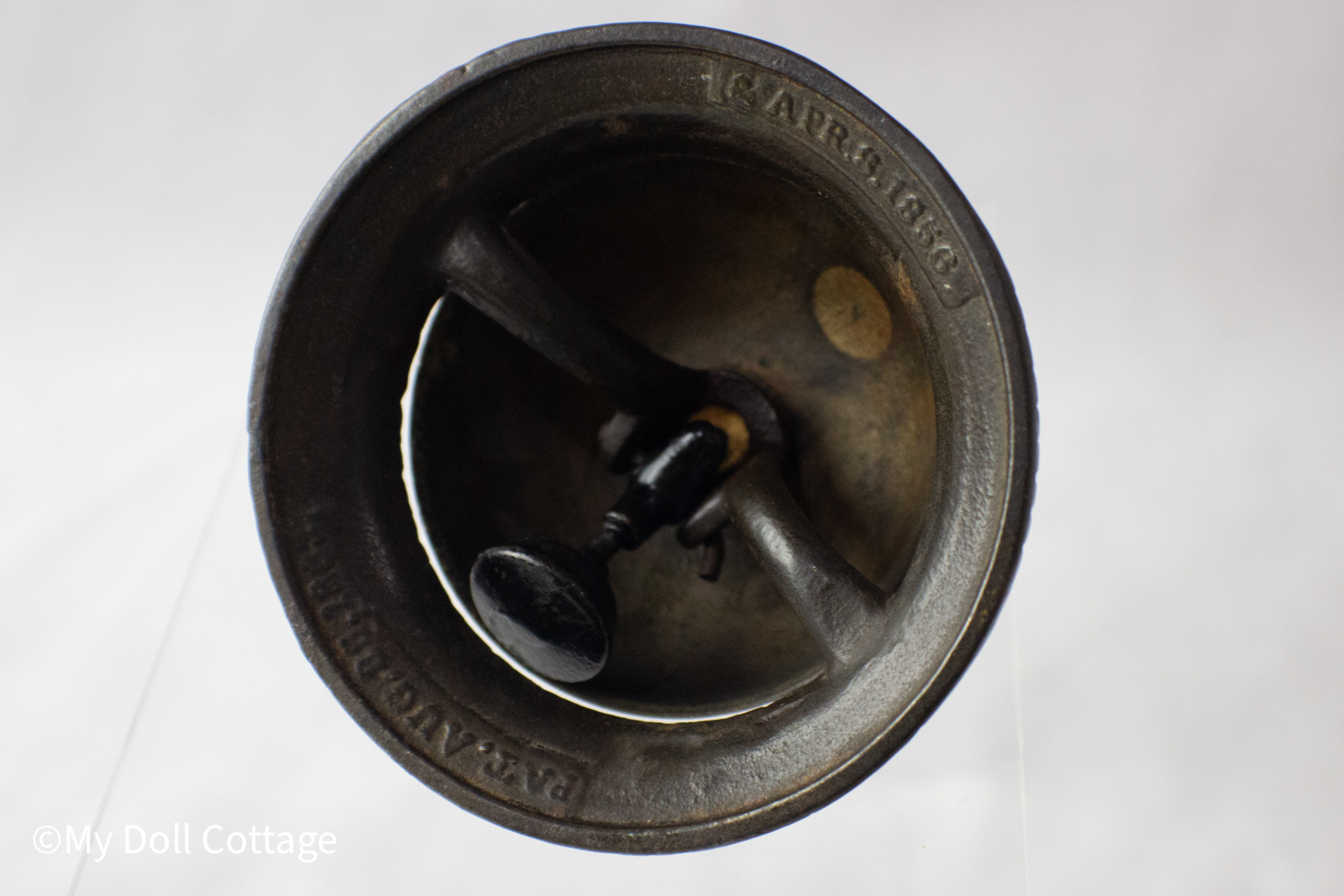 Underside view of bell interior showing cast iron structure and patent marking “APR. 8 1856.”