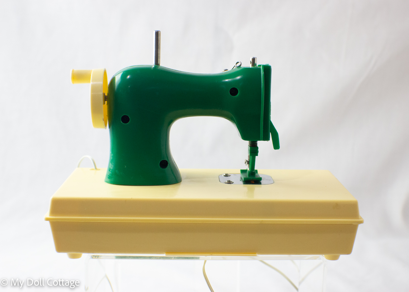 Side view showing winding handle and pedal connection.