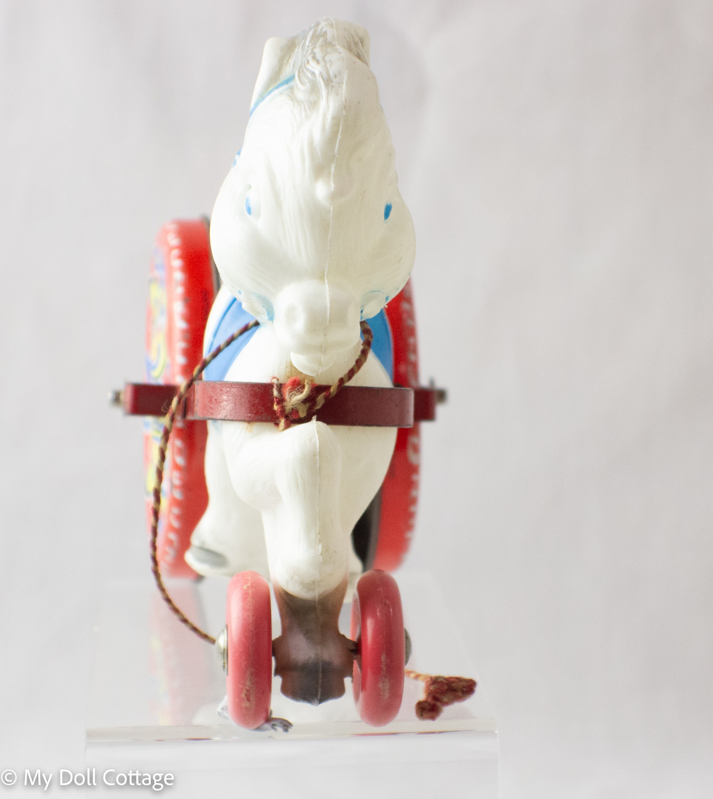 Front view of horse showing painted bridle detail and pull cord.