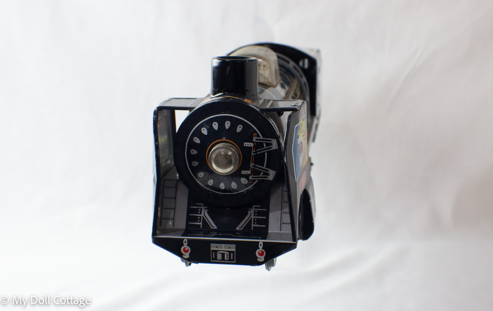 Front view of locomotive showing circular printed smokebox design and headlight detail.