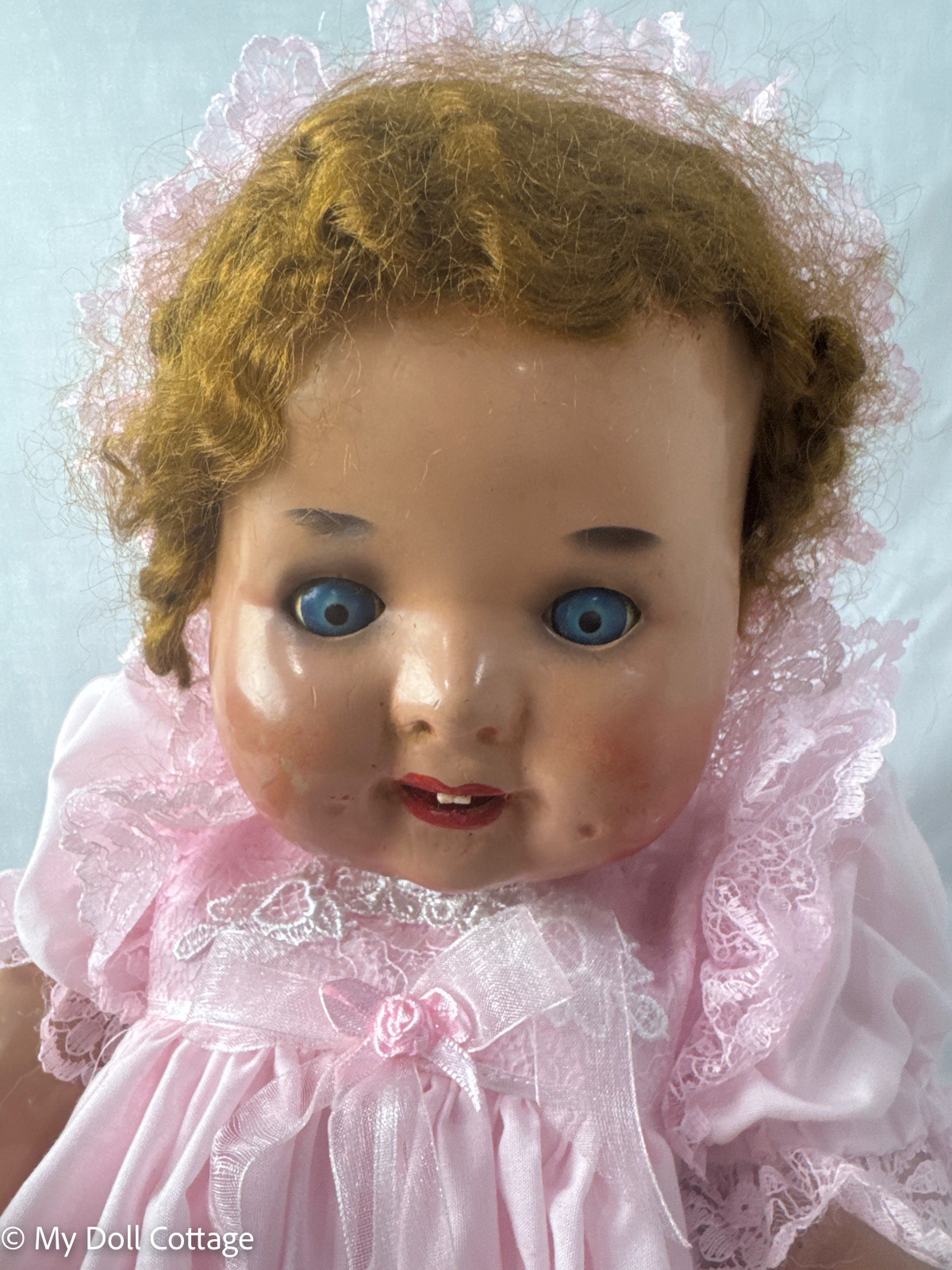Close-up of face showing blue sleep eyes and painted features