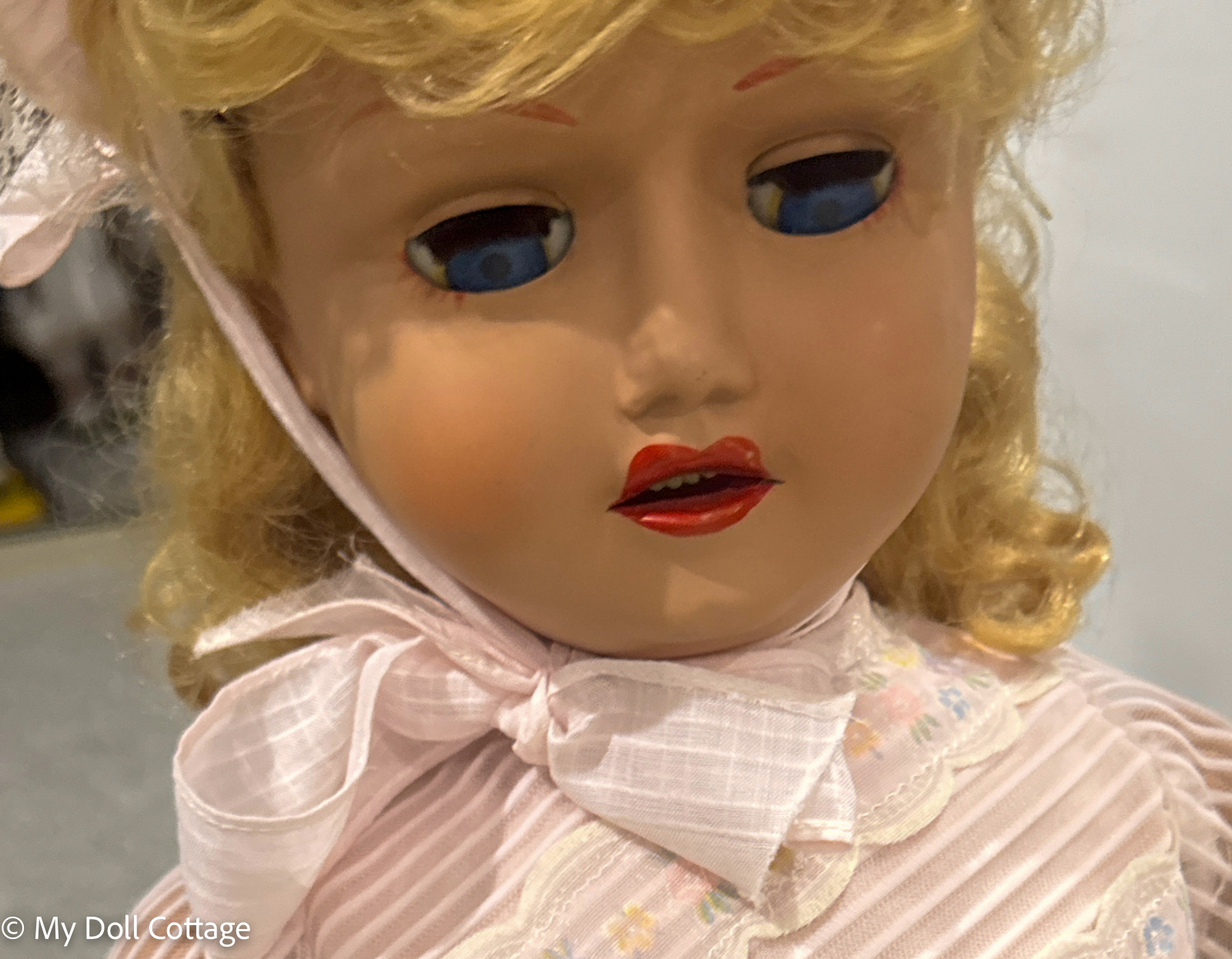 Close-up of face showing blue sleep eyes and painted features