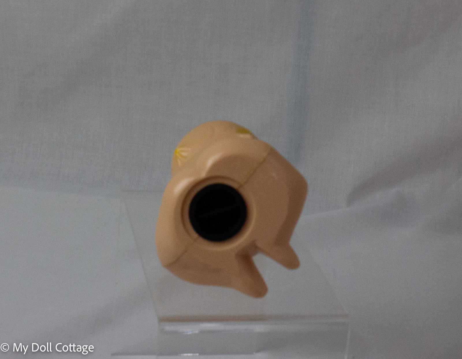 4. Underside of Kewpie powder dispenser showing circular fill opening and original black insert cap