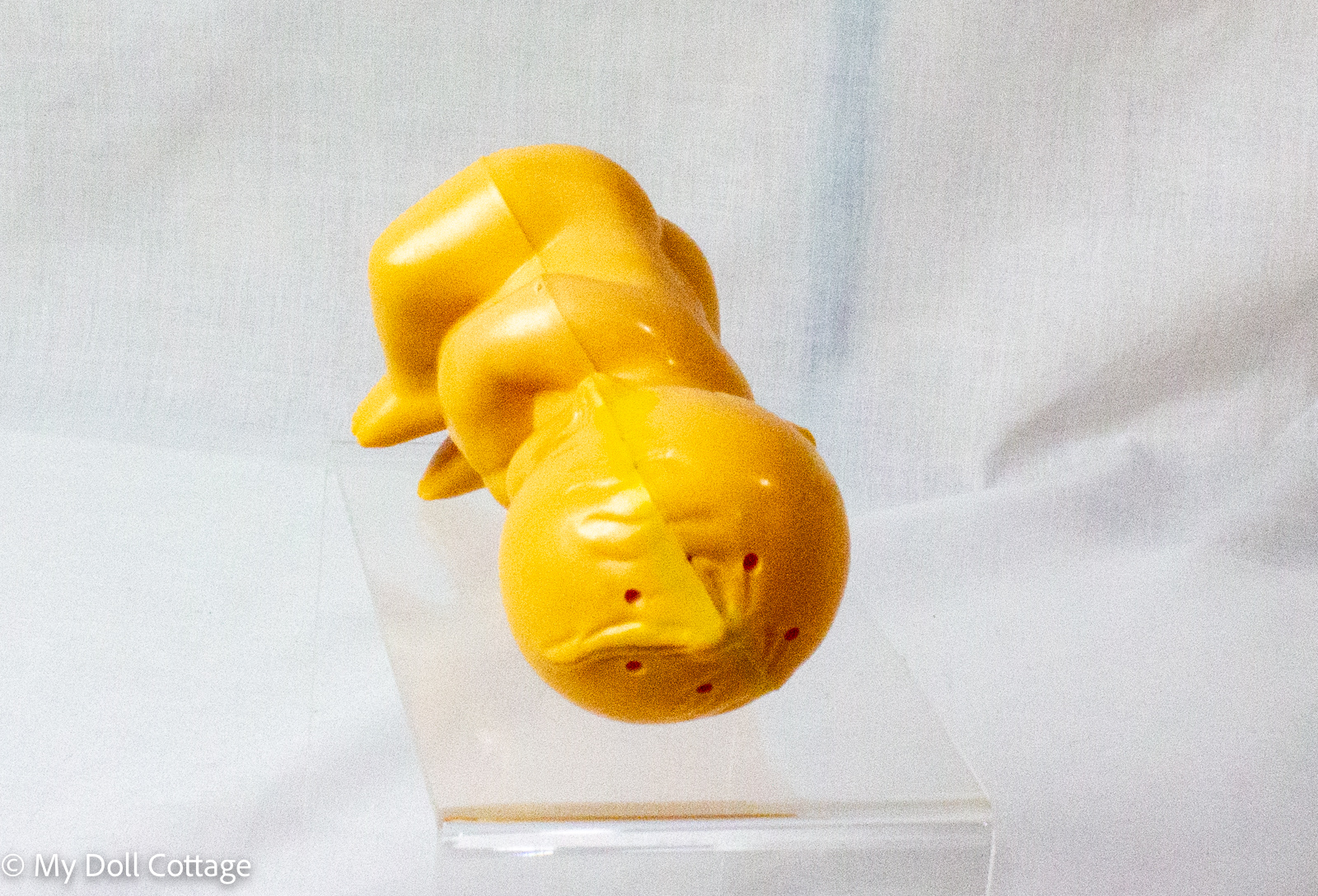 5. Top angled view of Kewpie powder dispenser displaying dispensing holes across moulded hair area.