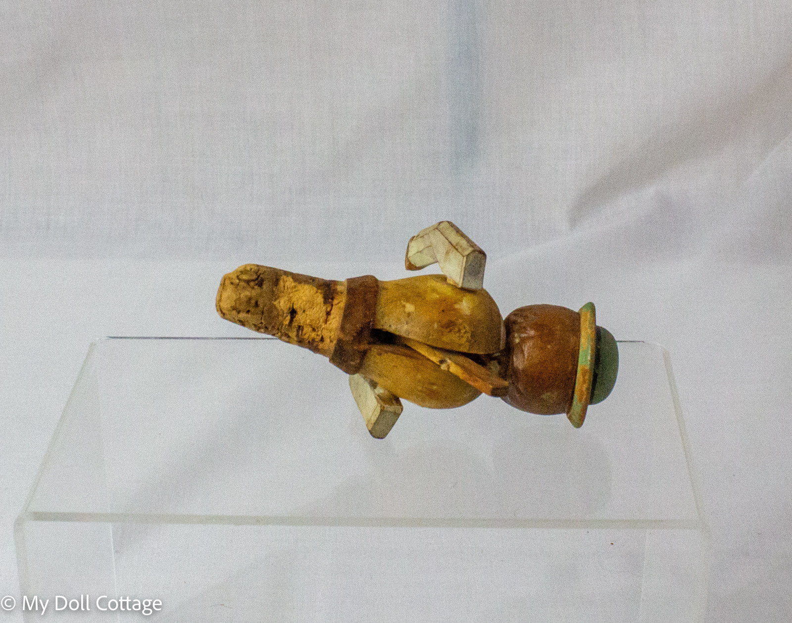 3. Angled view of ANRI carved bottle stopper displaying aged cork and painted facial details.