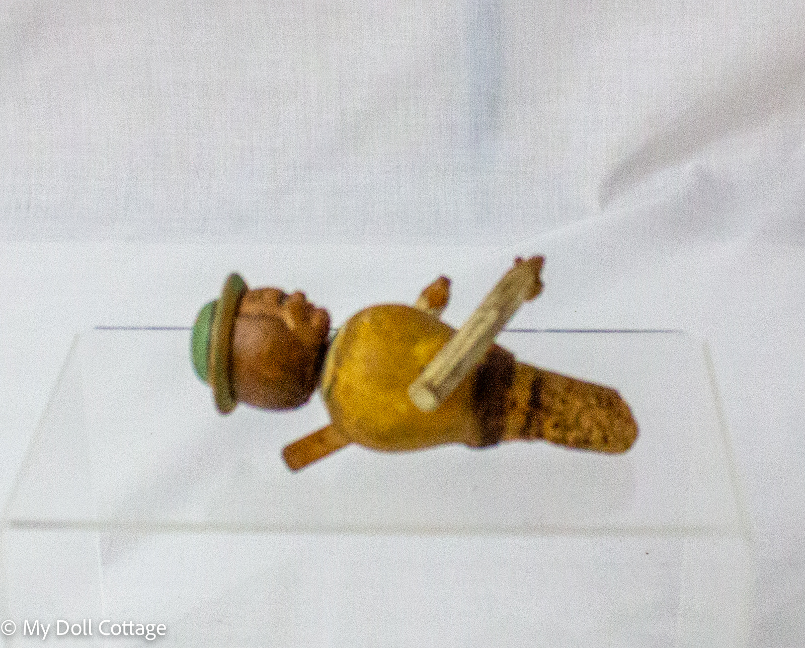 4. Top-down view of hand-painted wooden figural bottle stopper with cork insert and folk-art styling.