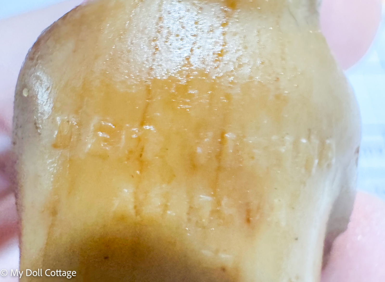 2. Detail view of impressed “Made in Austria” marking on vintage wax doll.