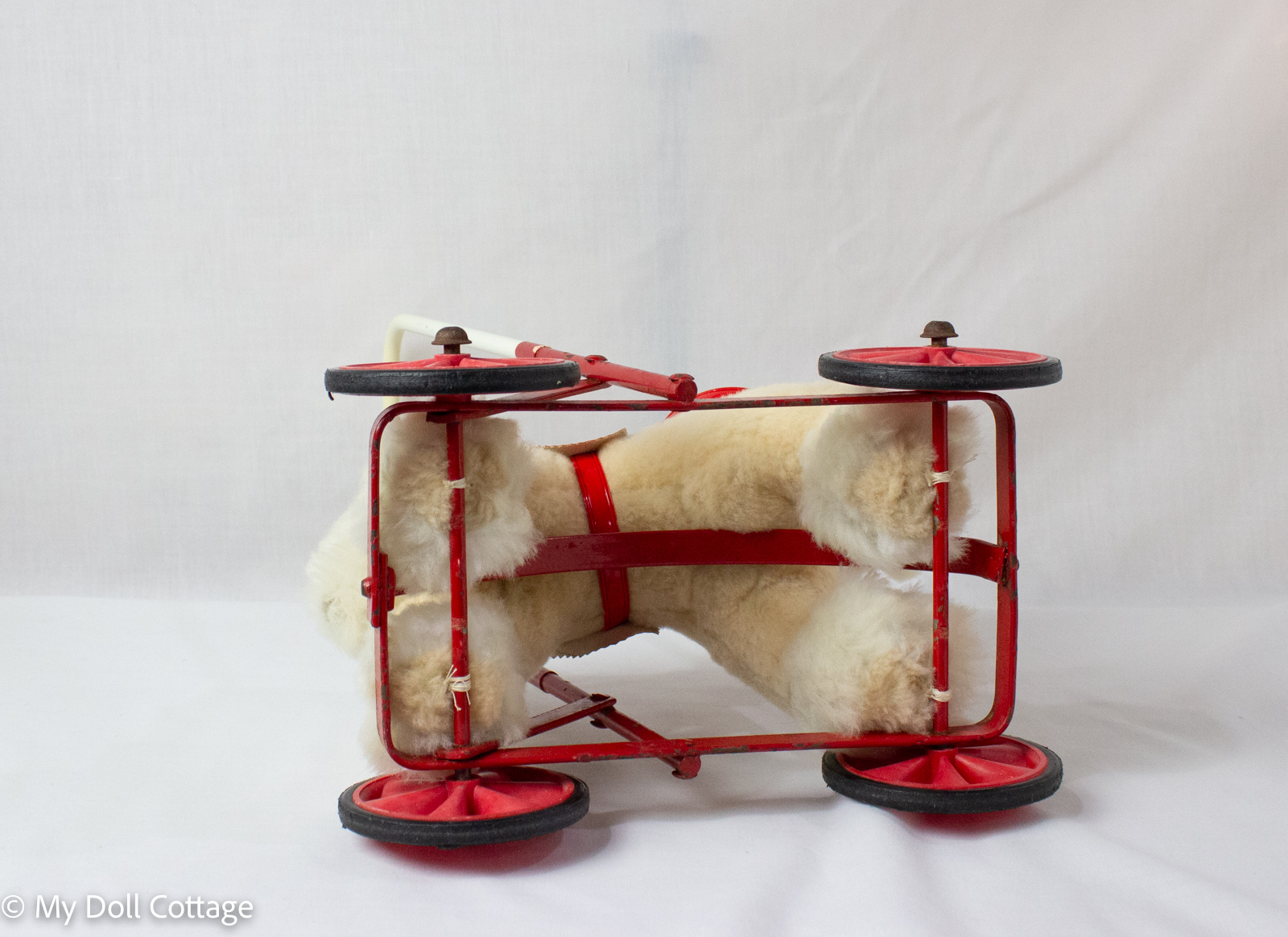 Underside view showing metal frame construction and wheel placement