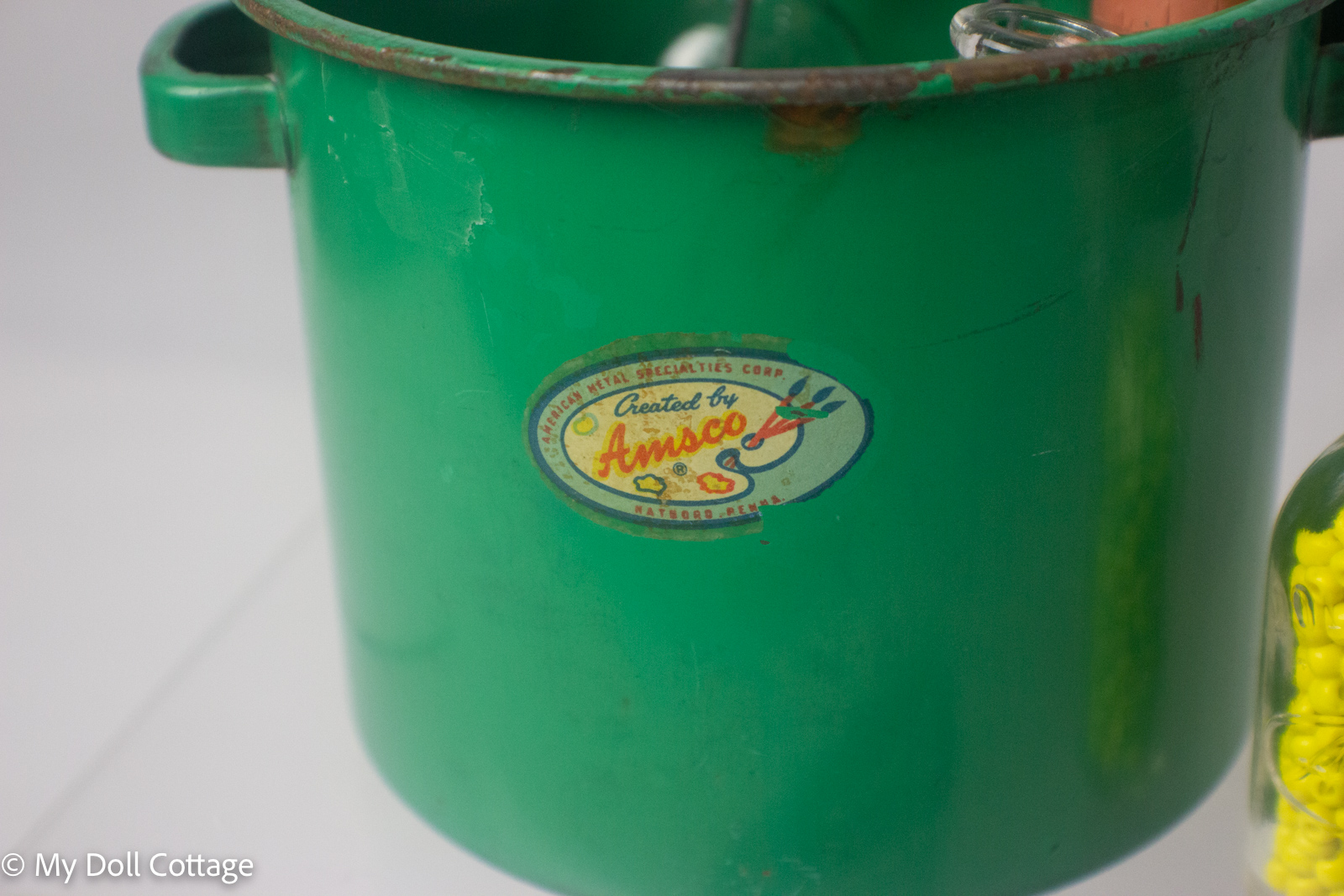 3. Green painted metal toy steriliser bucket with worn Amsco label.
