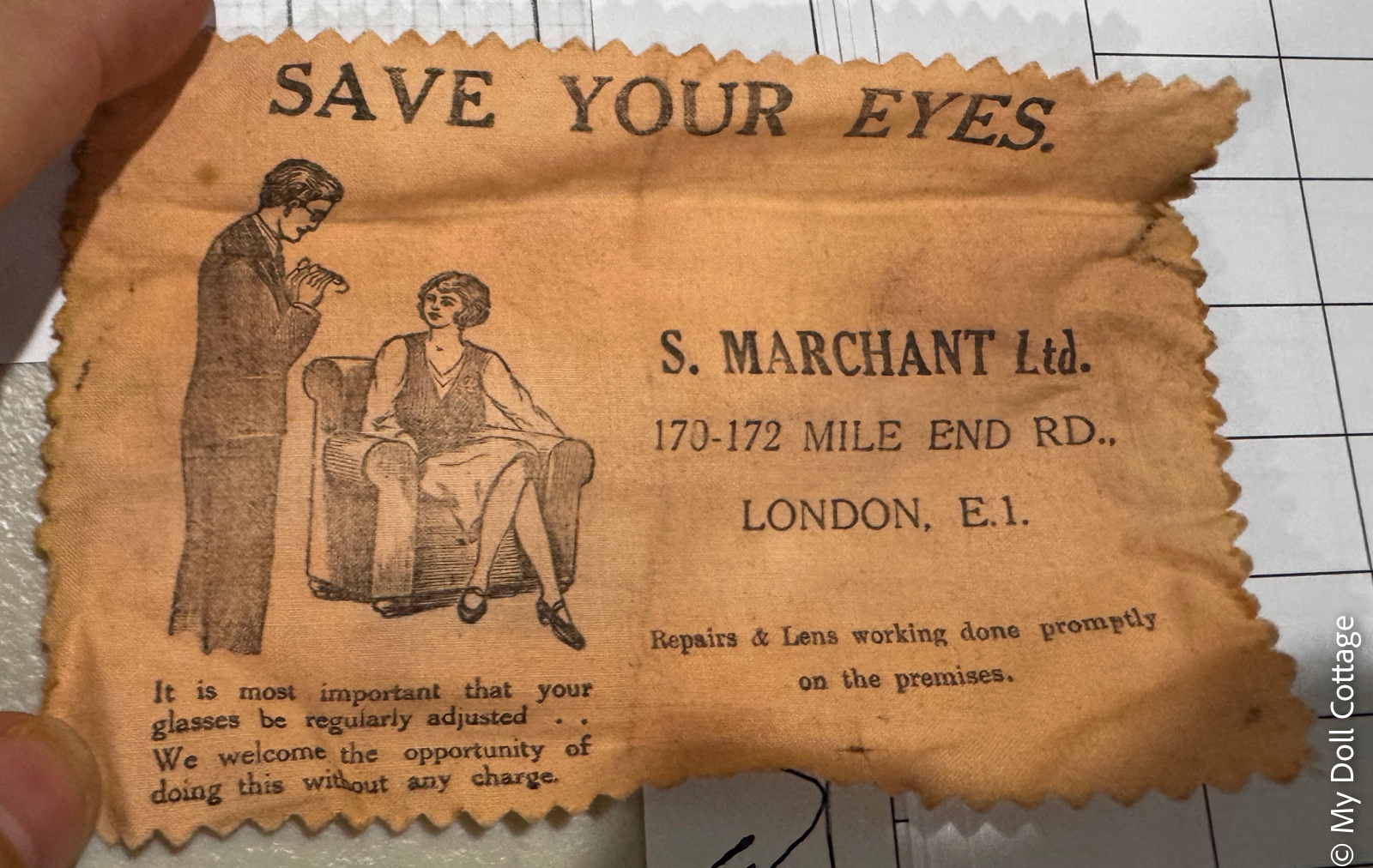 Close-up of the original S. Marchant Ltd 'Save Your Eyes' cleaning cloth advertising optical services at 170–172 Mile End Road, London E.1.